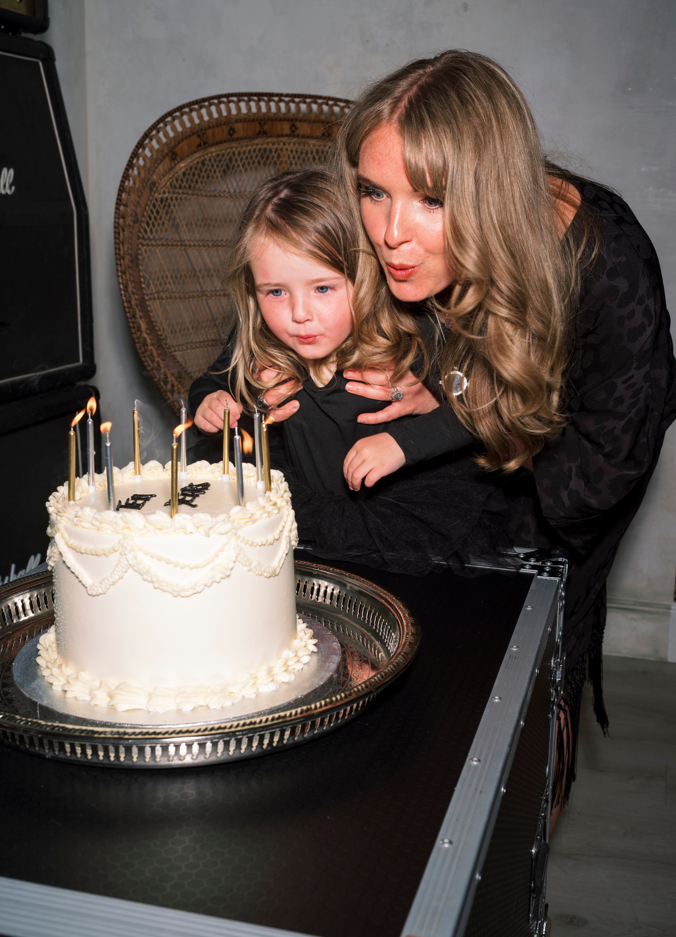 Little Lies co founder, Jade with daughter blowing out the candles on the 10 Years in business cake!
