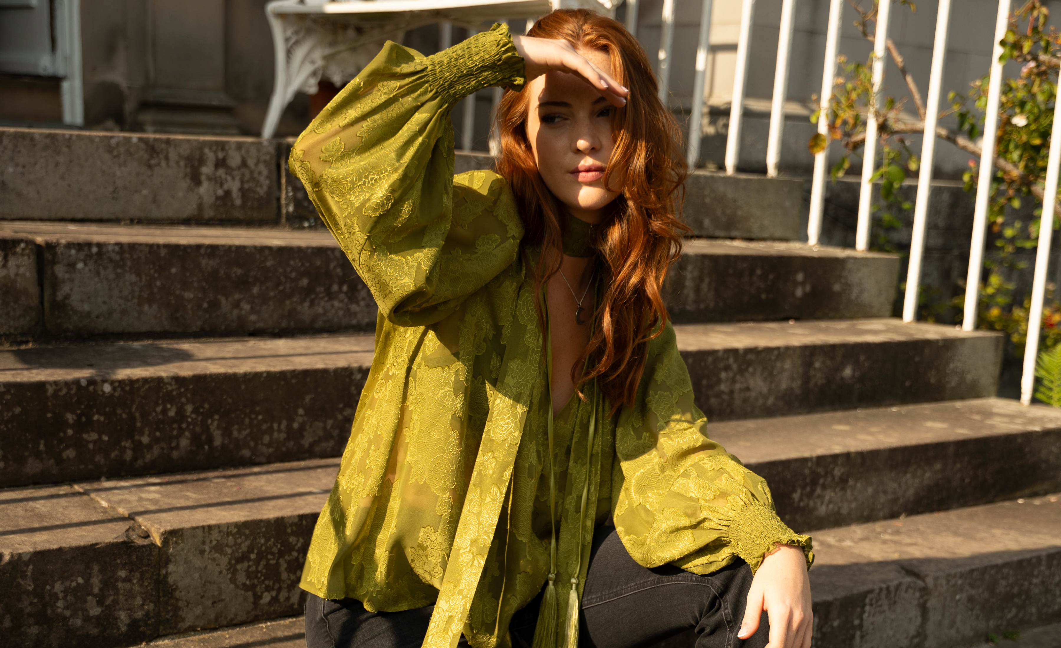 Anna wearing Cassia Olive Chiffon Smock Top sitting in the sun on stone steps at the Byre at Inchyra