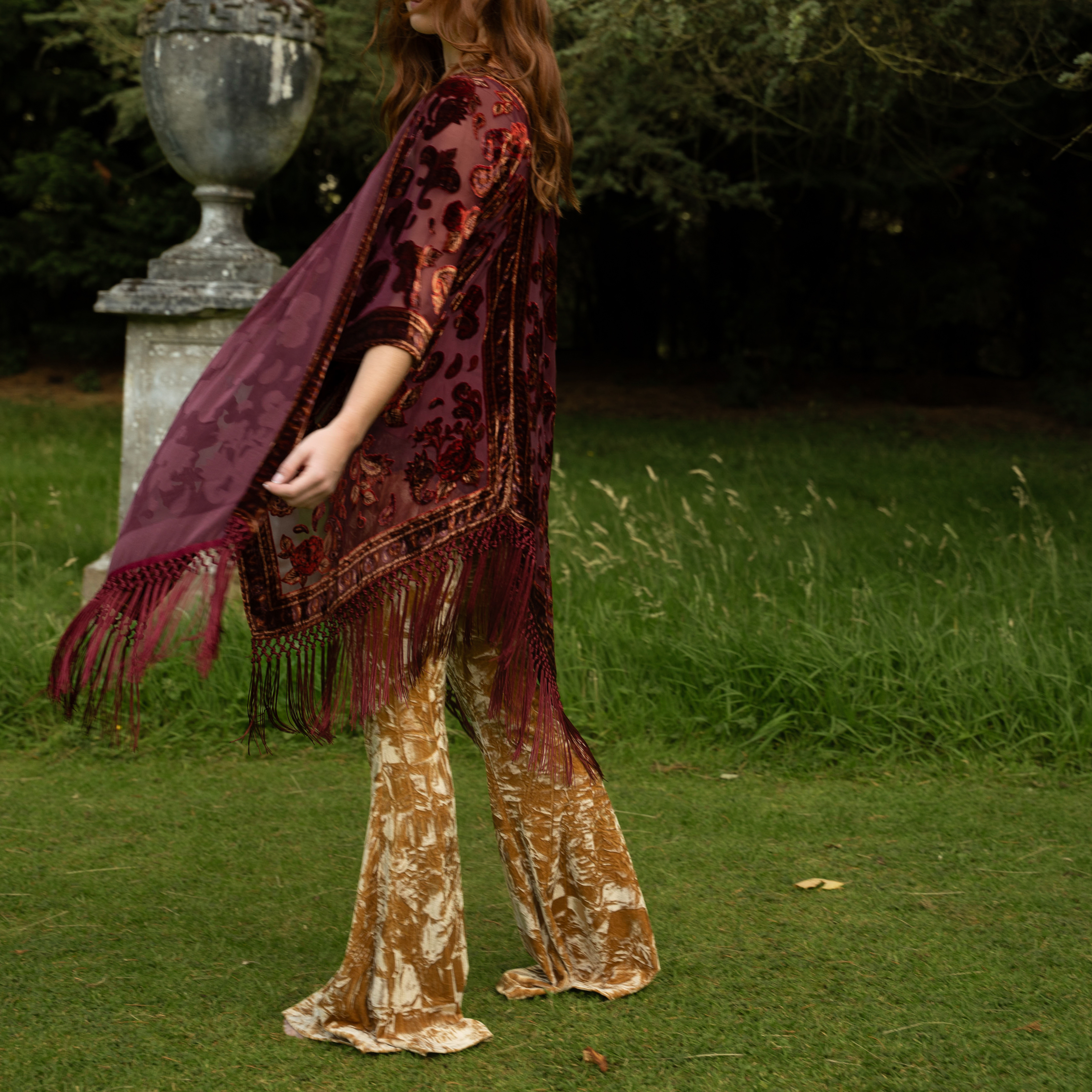 Anna wearing the Stevie Paisley Plum kimono with Hendrix Ochre Velvet Flares in country estate.