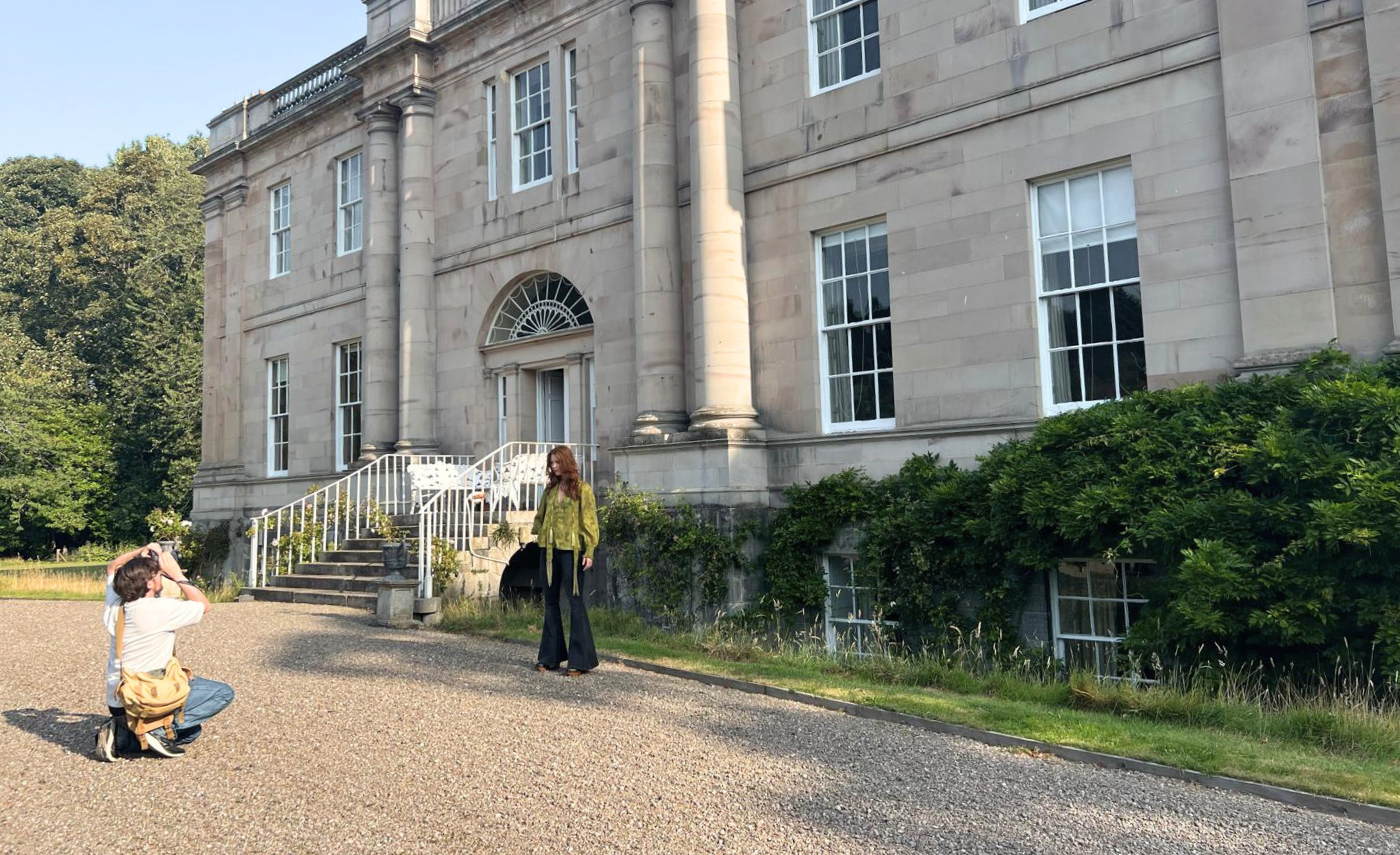 Behind-the-scenes campaign shoot with Anna wearing the Cassia Olive Chiffon Smock Top outside country estate The Byre at Inchyra