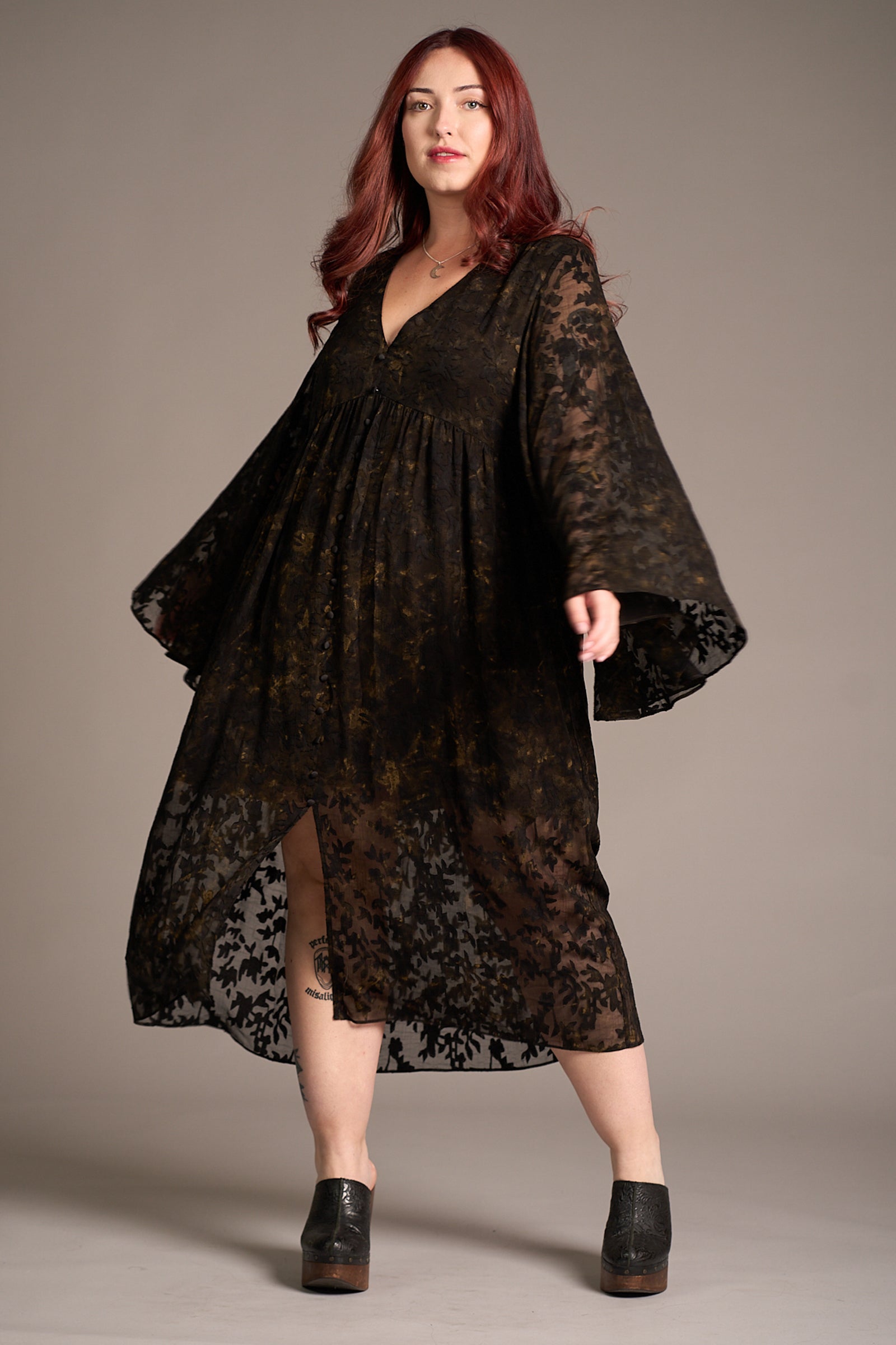 Taylor wearing Bella Donna Midi Dress featuring deep V-neckline, sheer floral sleeves, against a neutral backdrop, Stevie Nicks inspired styling studio