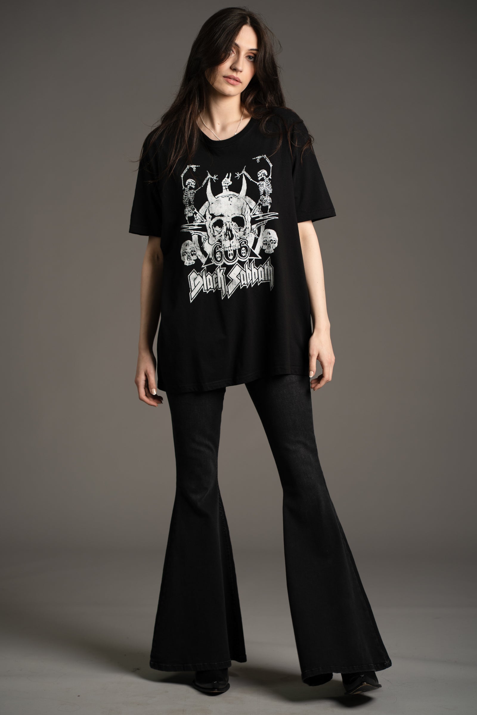 Model Andie wearing oversized Black Sabbath Dancing Band graphic tee styled with Hendrix Denim flares from Little Lies