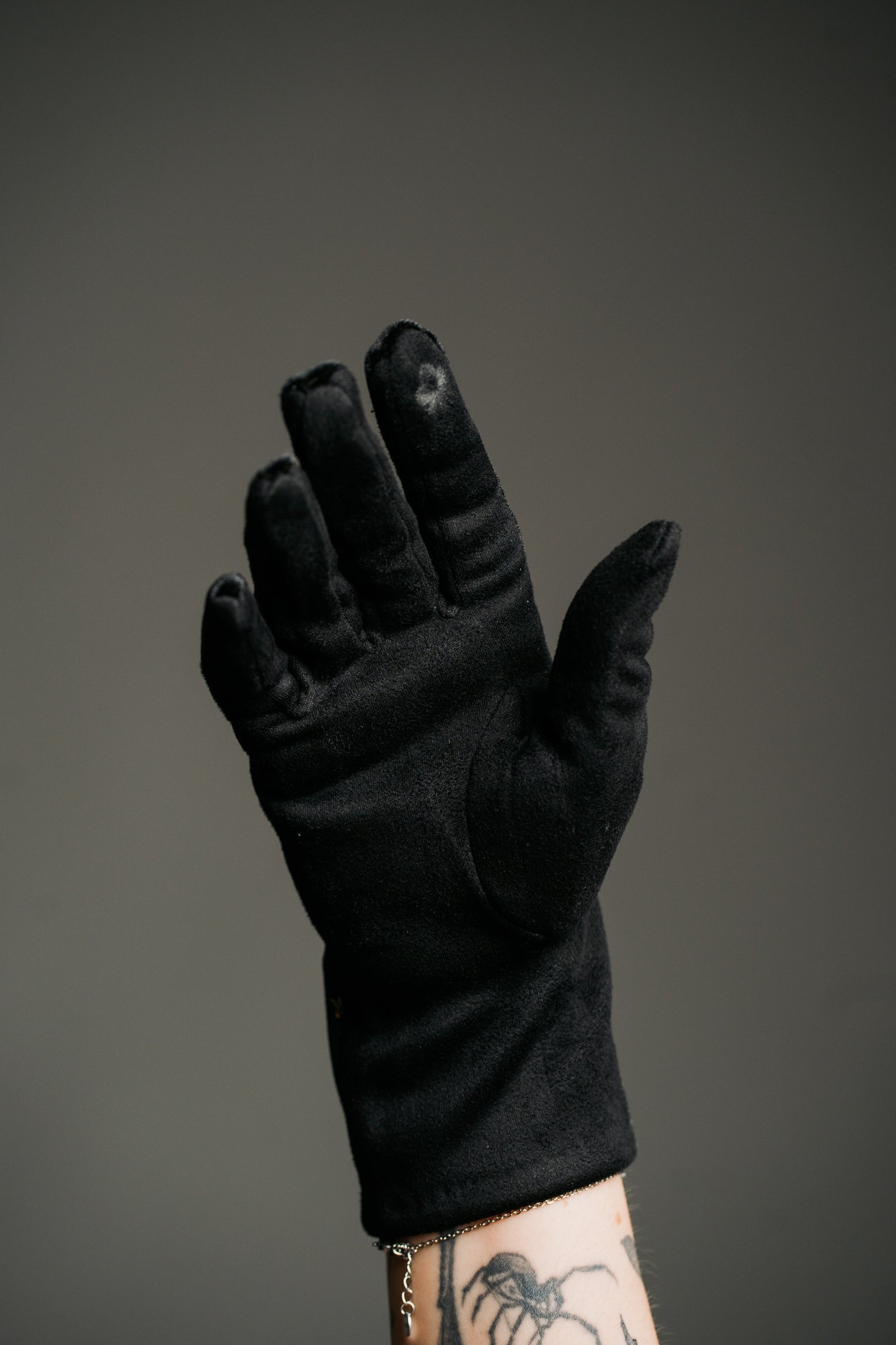 Product shot showcasing the Black Velvet Celestial Gloves, smooth black fabric with close up of touchscreen friendly tip.