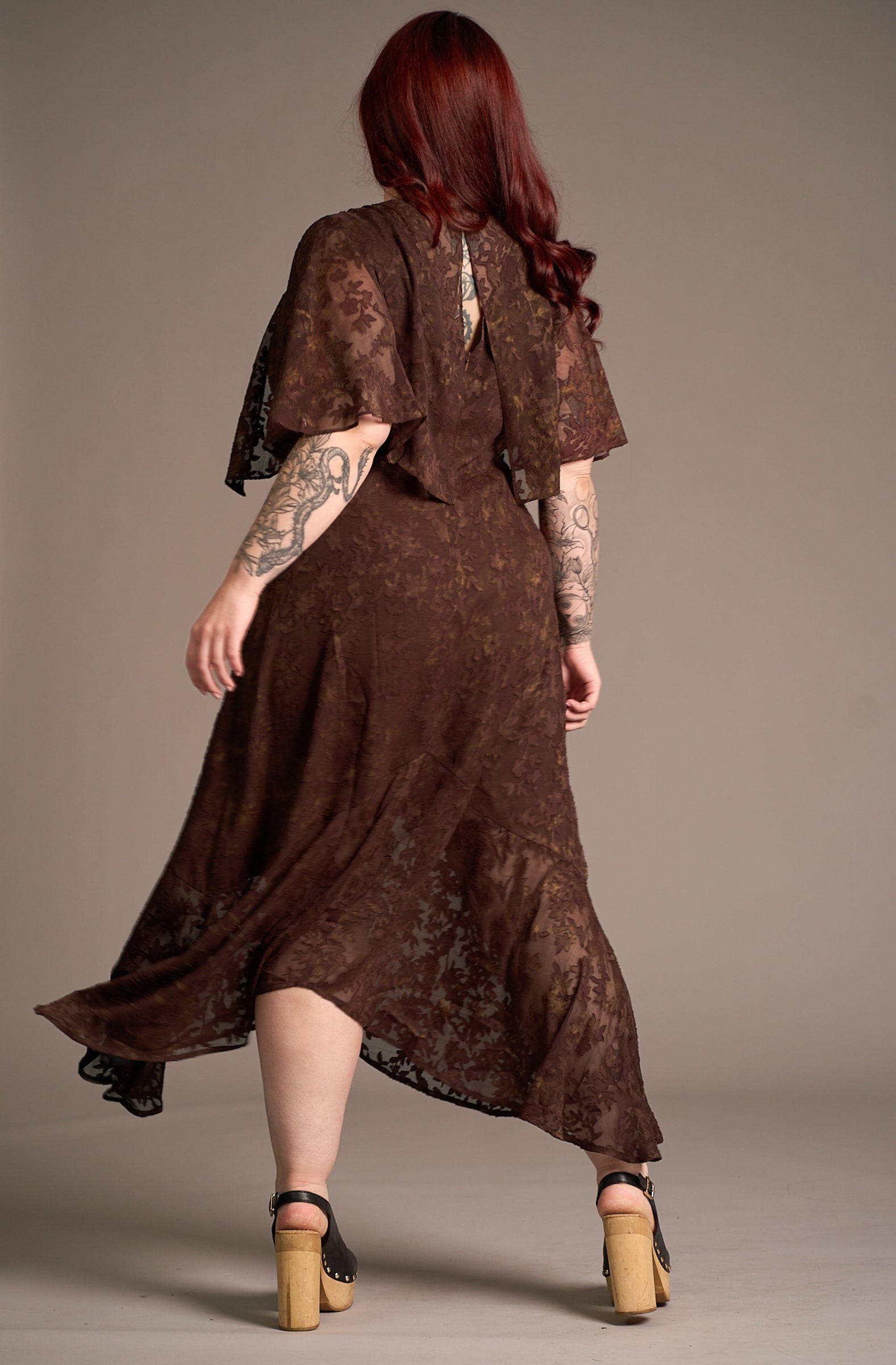 Taylor showing the back of the Brown Sugar cape maxi chiffon dress, Stevie nicks inspired styling studio