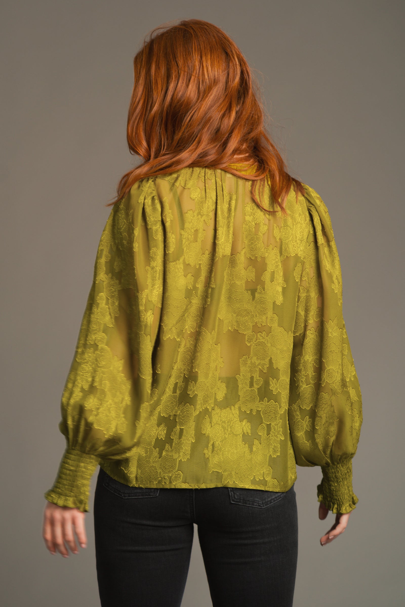 Back view of Cassia Olive Smock top showing lightweight chiffon fabric and flowy drape
