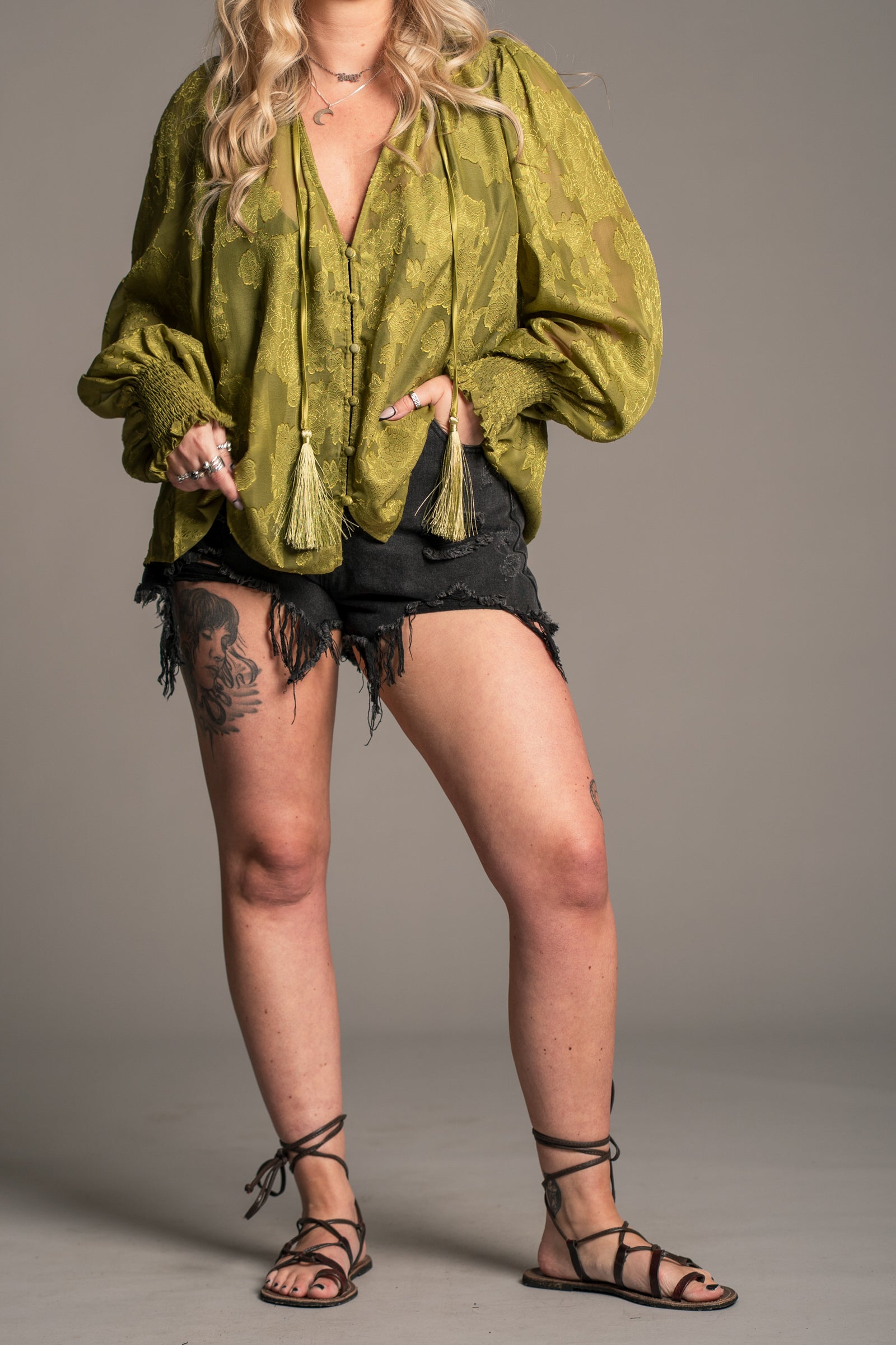 Little Lies Cassia olive chiffon smock top with floral texture, tie neck tassels and relaxed drape, close‑up detail view