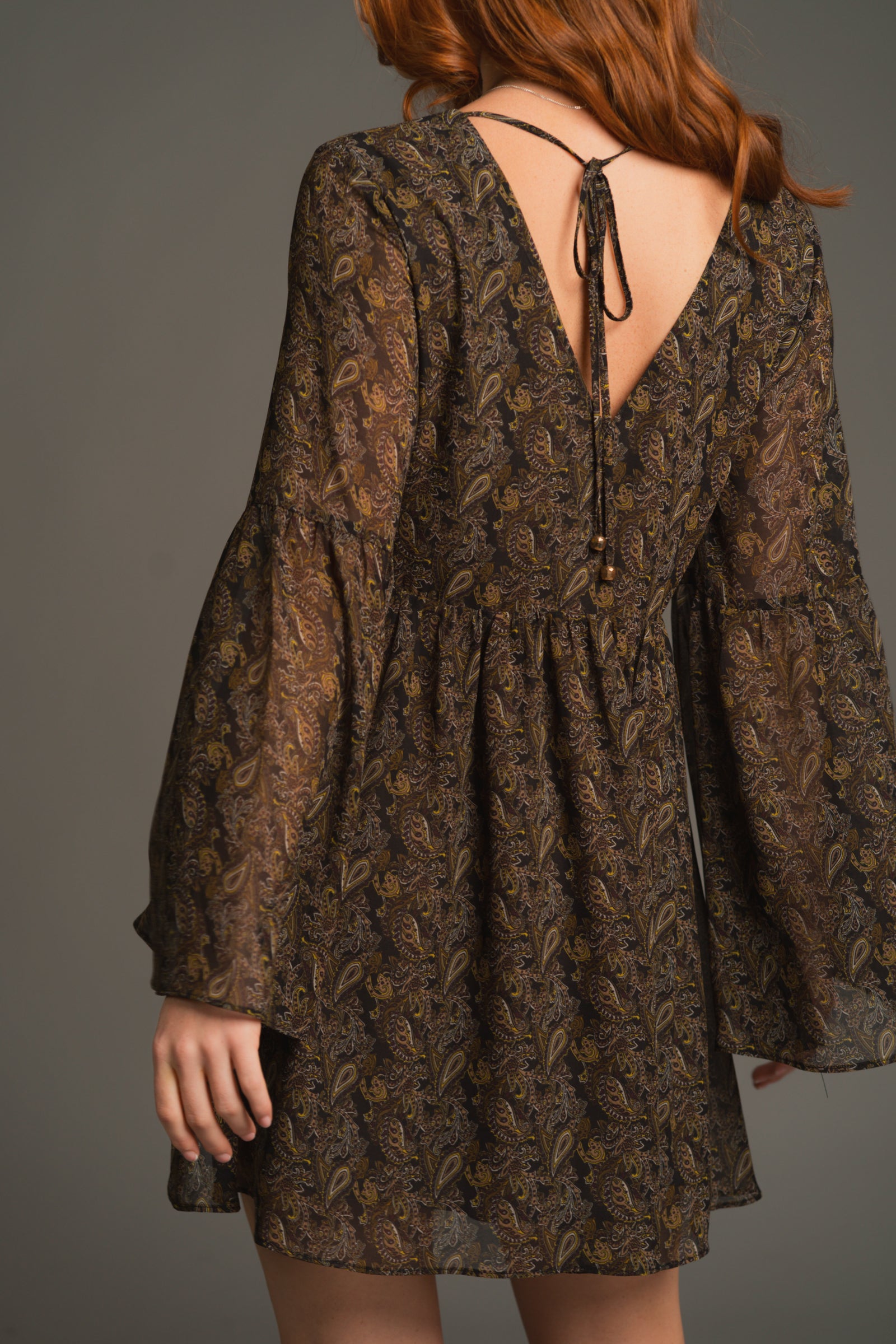 Back view of Cinnamon Girl Paisley Chiffon Smock Dress with flared sleeves and relaxed, twirl-ready mini fit