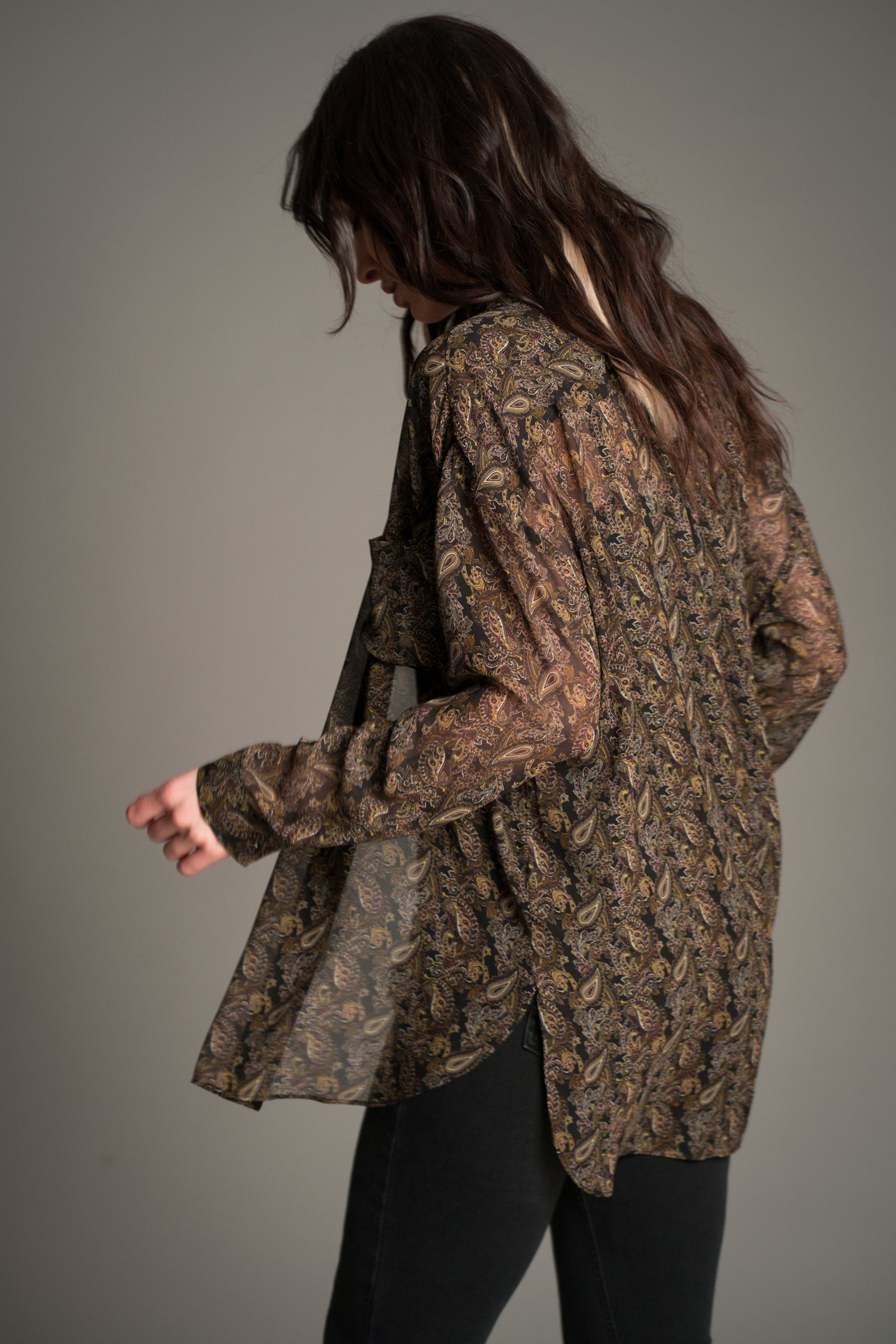 Little Lies Cinnamon Girl Paisley Chiffon Shirt shown from the back in a flowing sheer fabric with an all‑over boho paisley print.