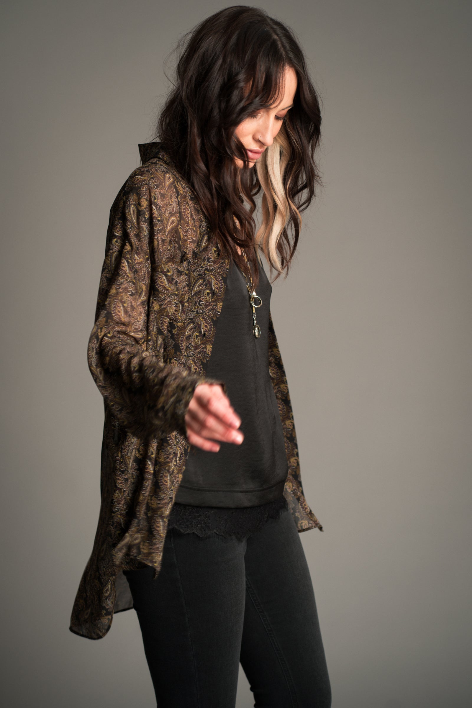 Little Lies Cinnamon Girl Paisley Chiffon Shirt worn open over a black satin cami, showcasing the lightweight sheer paisley fabric and relaxed flowing fit.