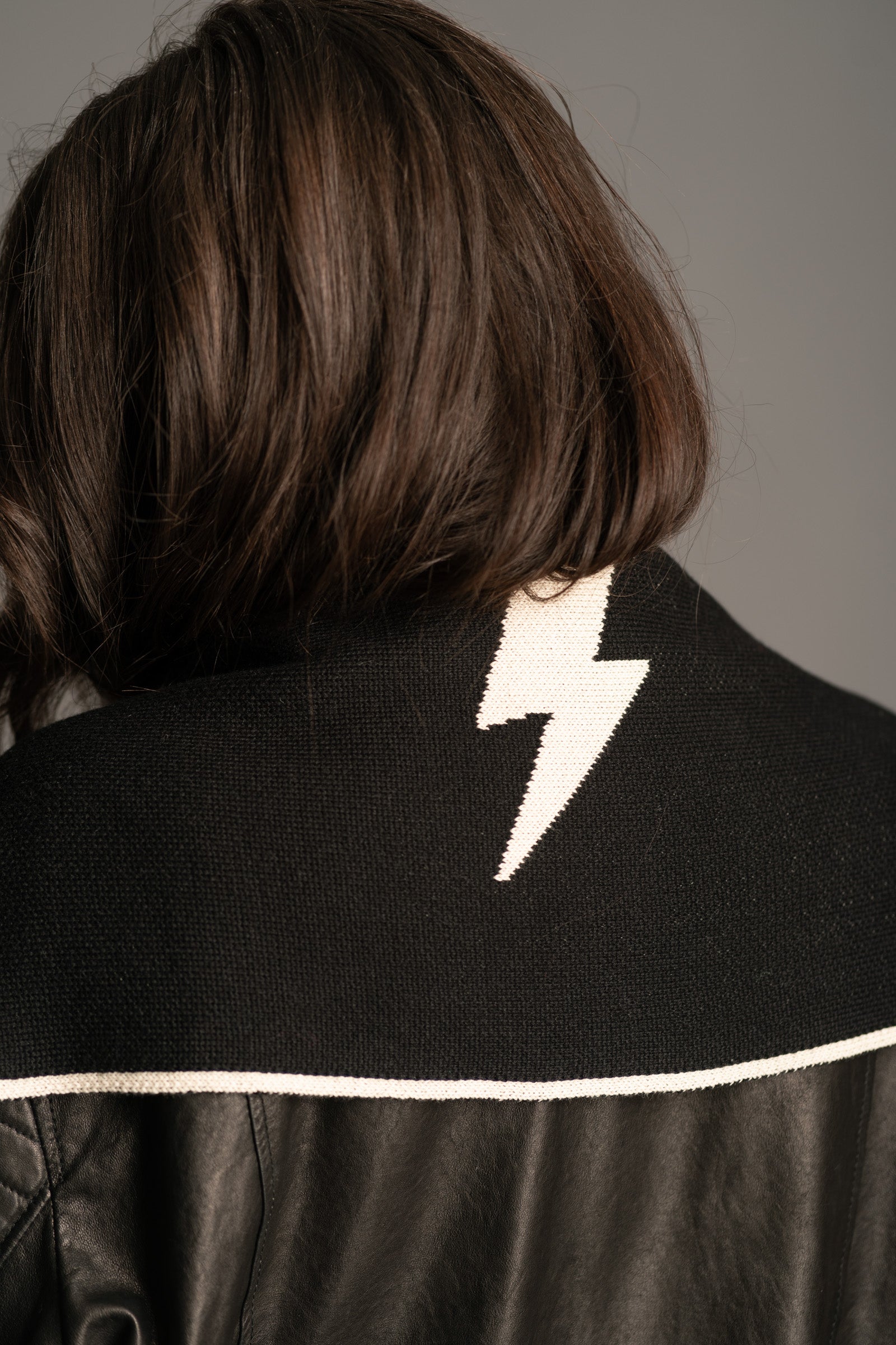 Back view of the Little Lies Rebel Rebel Knit Scarf showing white lightning bolt motif and contrast trim detail