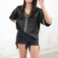 Model wearing Heavy Metal Studded Tee- Relaxed fit, black satin boxy tee with silver Embellishment