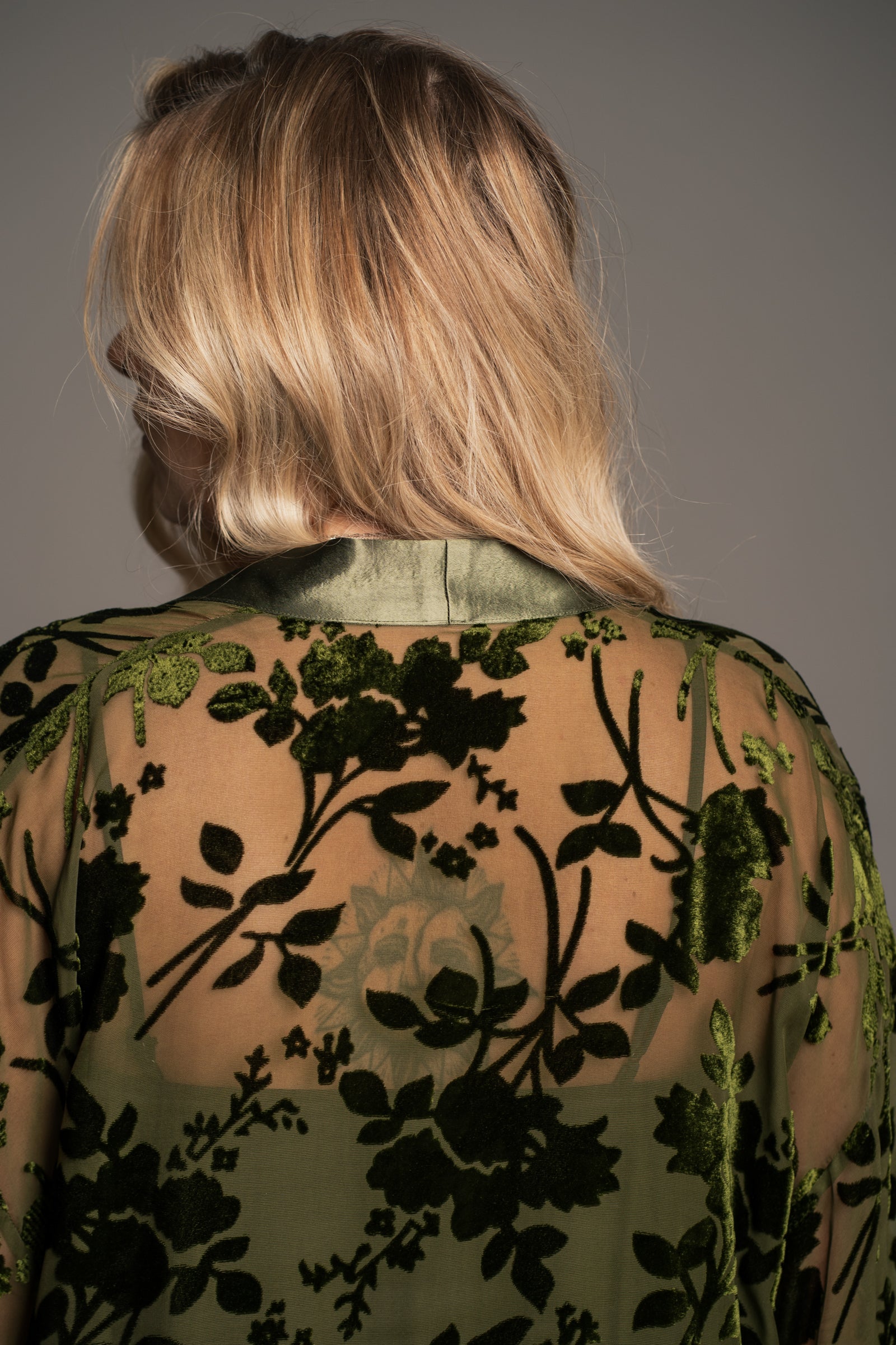 Close-up of Little Lies Dakota kimono neckline showing sheer olive devore fabric with soft velvet floral texture and satin trim