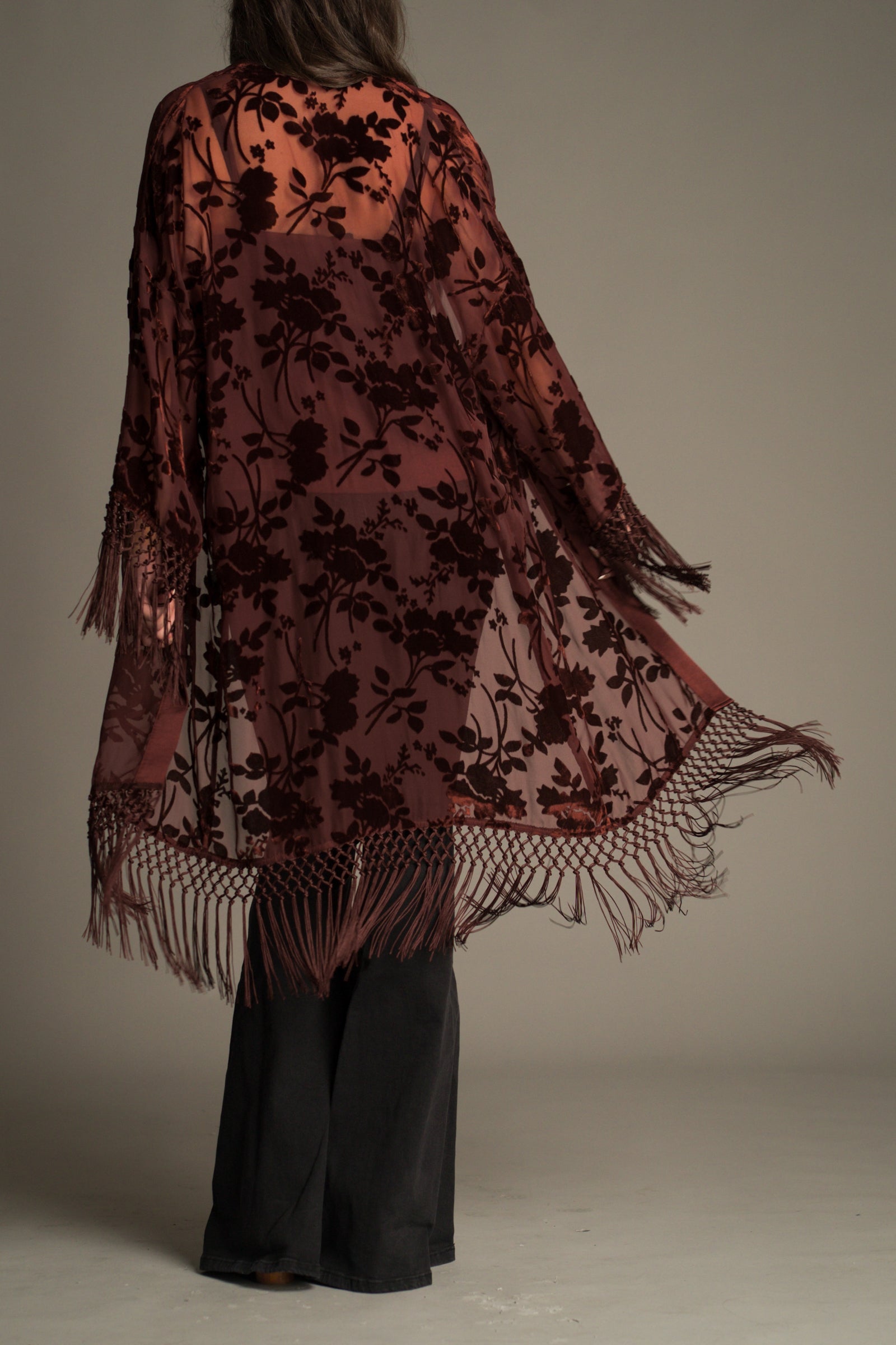Close-up of the tassel fringe and rust satin trim detail on the Dakota Rust Devore Kimono.