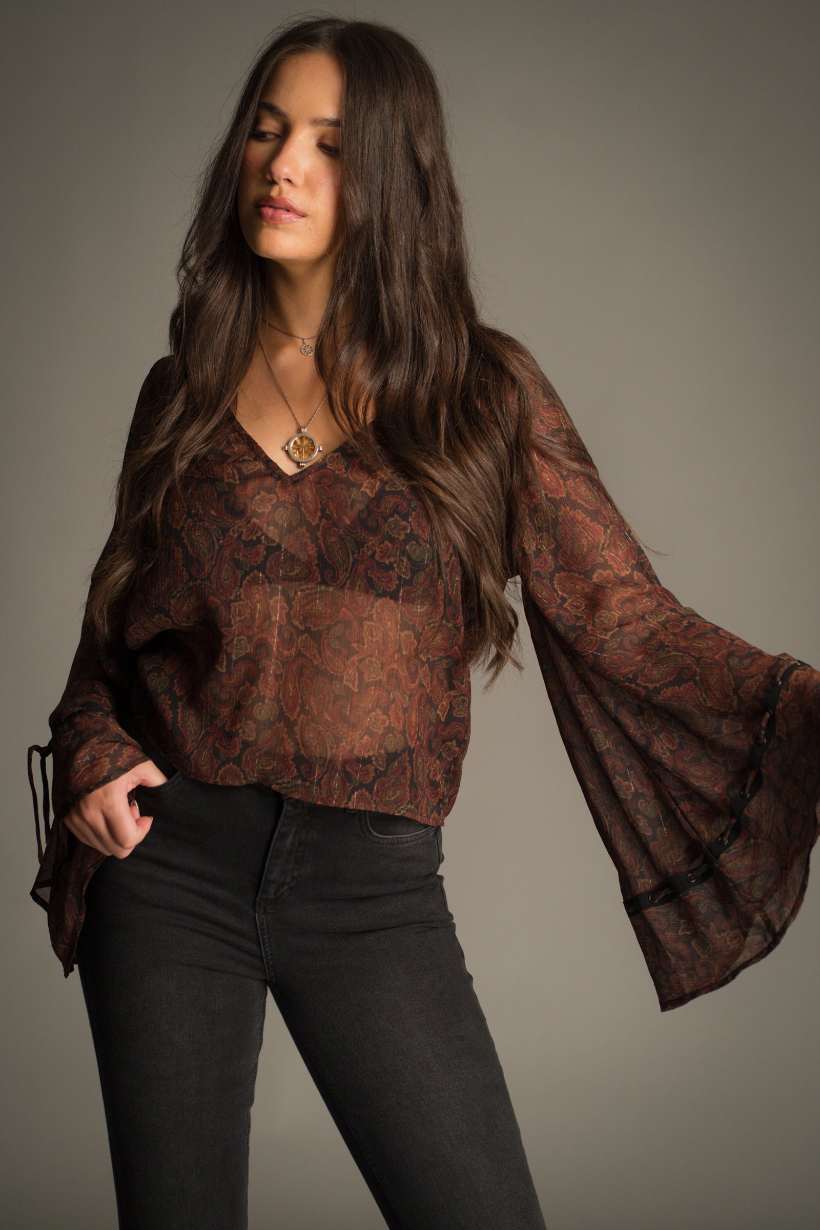 The Dark Paradise Paisley Boho Top showing V neckline and flared sleeve silhouette.