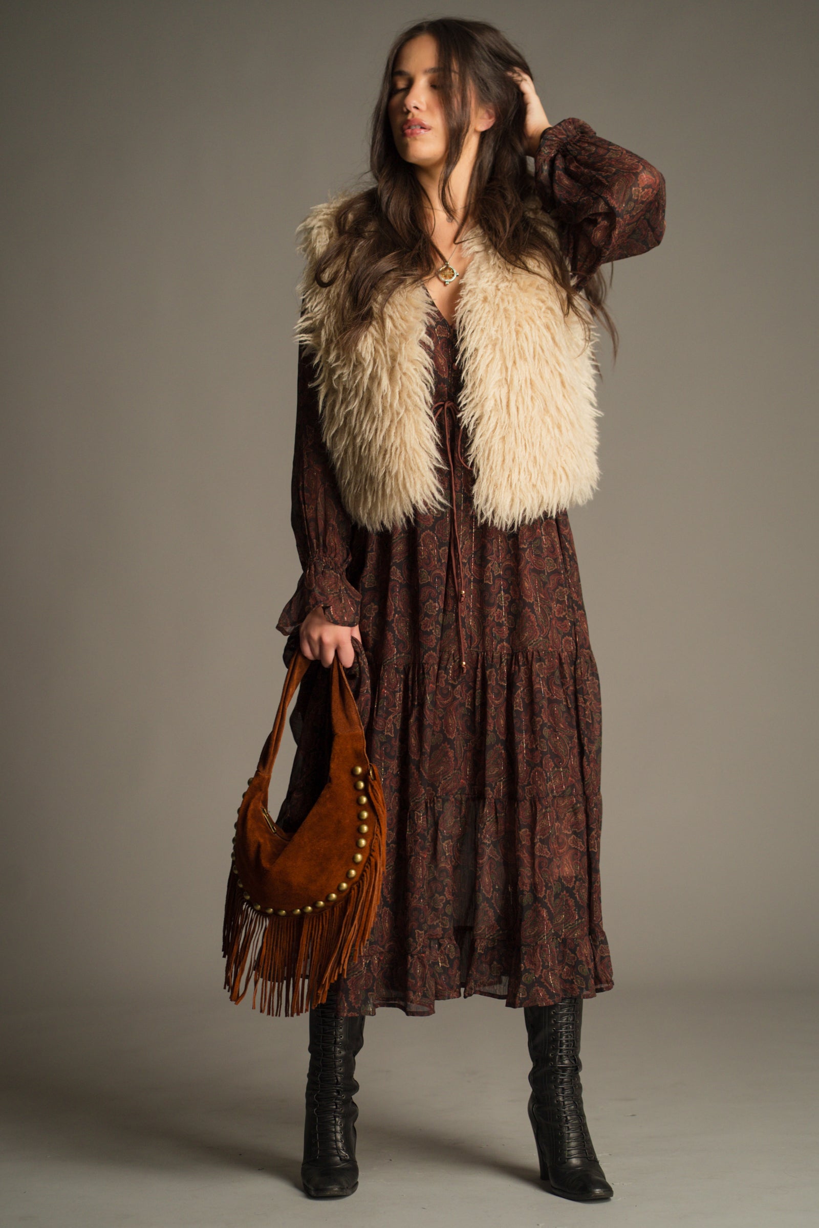 Little Lies Penny Lane Faux Mongolian Fur Gilet styled with the Dark Paradise Paisley Maxi Dress and a suede fringe bag for a boho-inspired autumn look