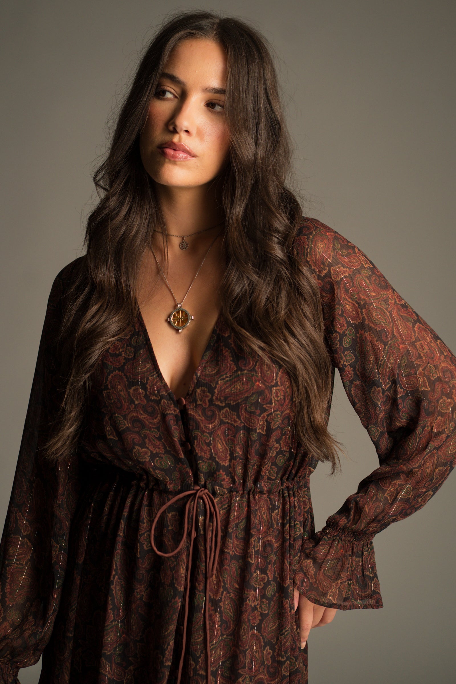 Close-up of the jewel-toned paisley chiffon and gold bead waist tie detail on the Dark Paradise Maxi Dress.