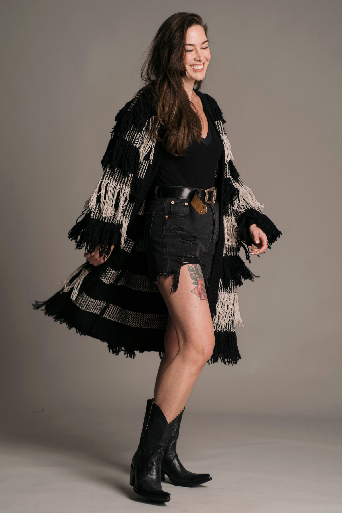 Model wearing Desperado fringe knit midi length Cardigan. the perfect western styling layer