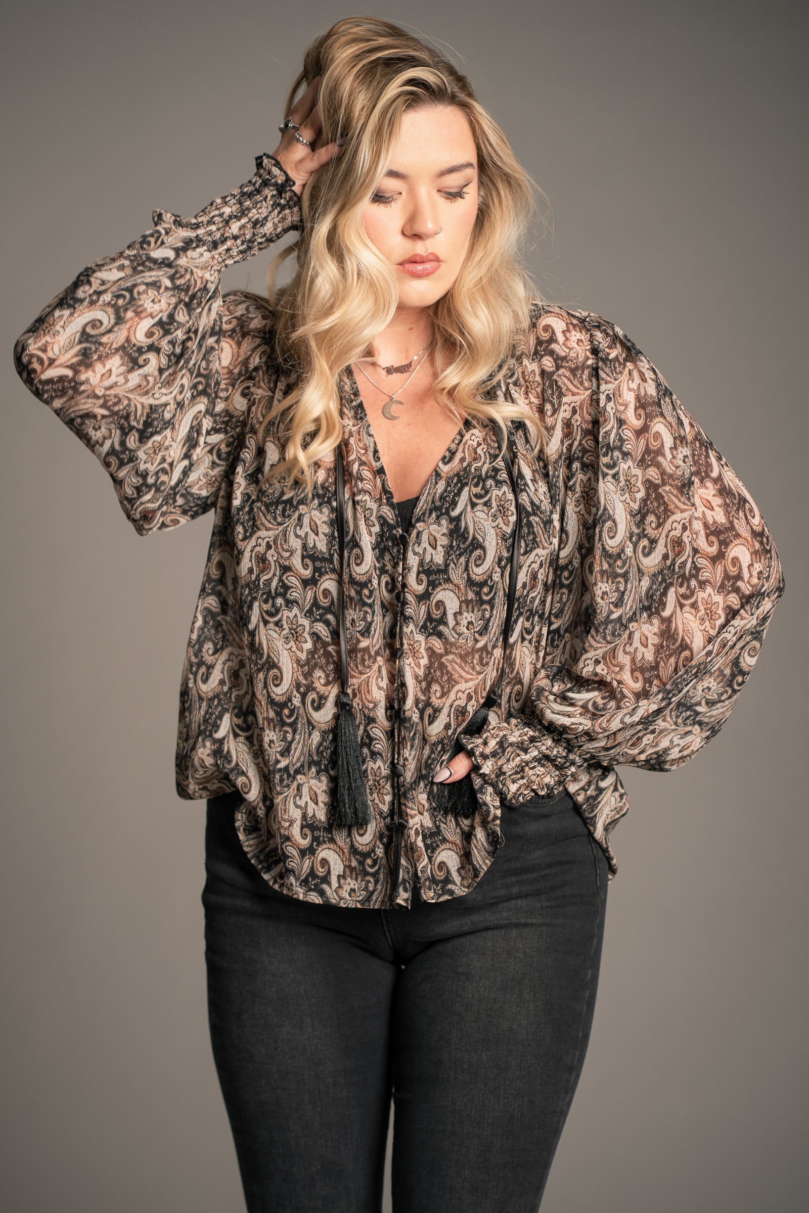 Little Lies Eleanor paisley smock top with relaxed fit, button front and tassel tie neckline in black and neutral paisley print
