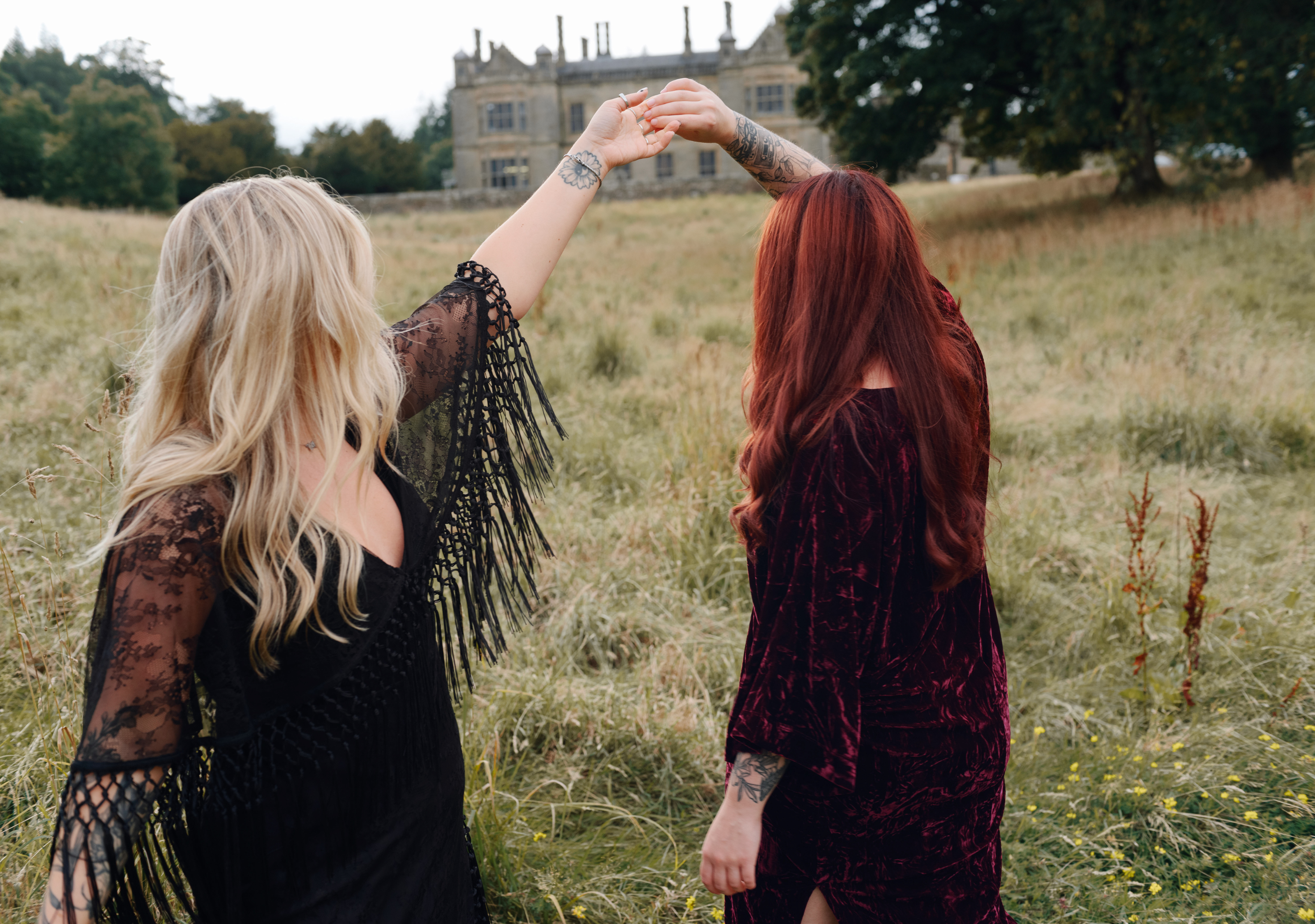 Erin wears Tango in the Night Lace Midi Dress, Taylor wears Rumours Merlot Velvet Midi Dress on Stevie Nicks inspired shoot outside a vintage manor