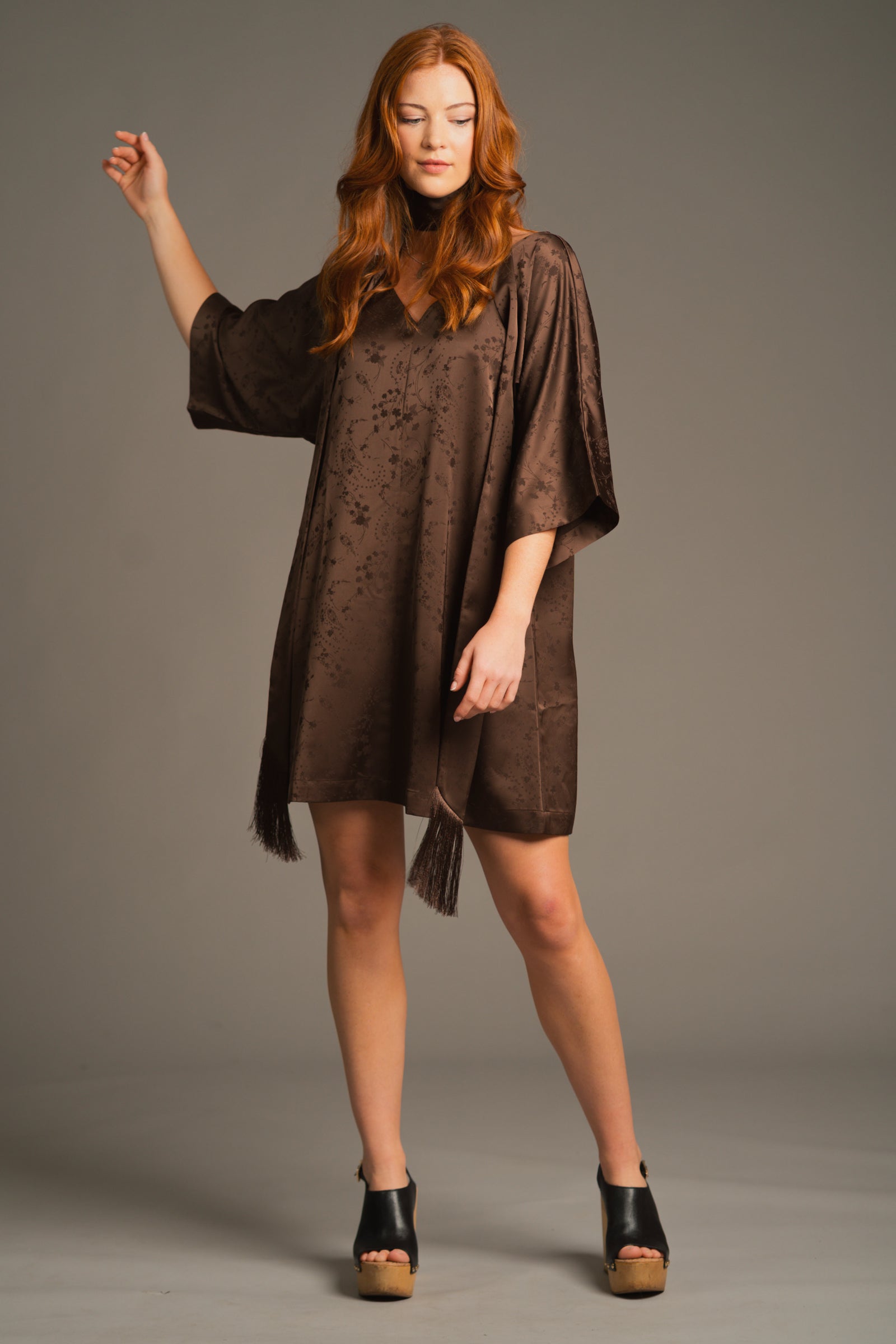 Lifestyle pose capturing movement and flow of the Evermore Espresso Batwing Mini Dress