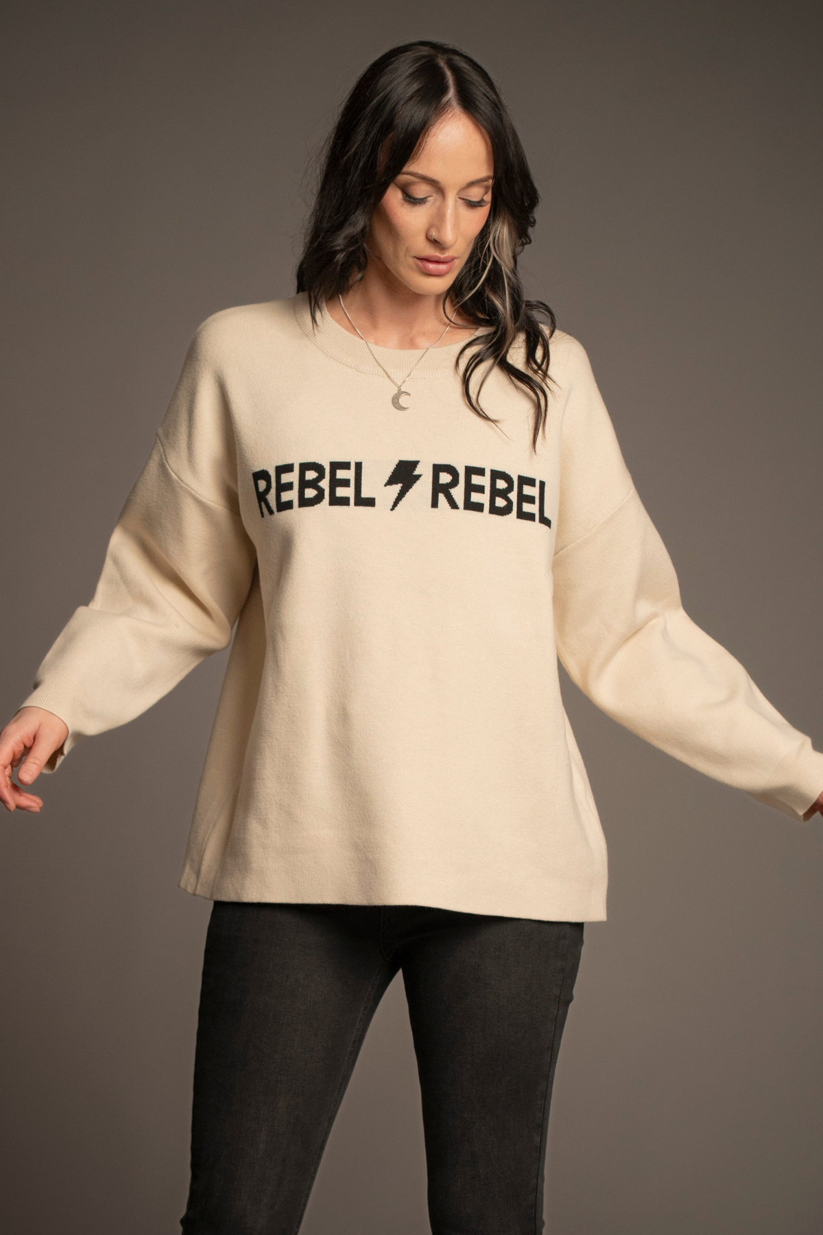 Victoria wearing the Rebel Rebel Cream Knit Jumper with Hendrix Denim Flares — front view