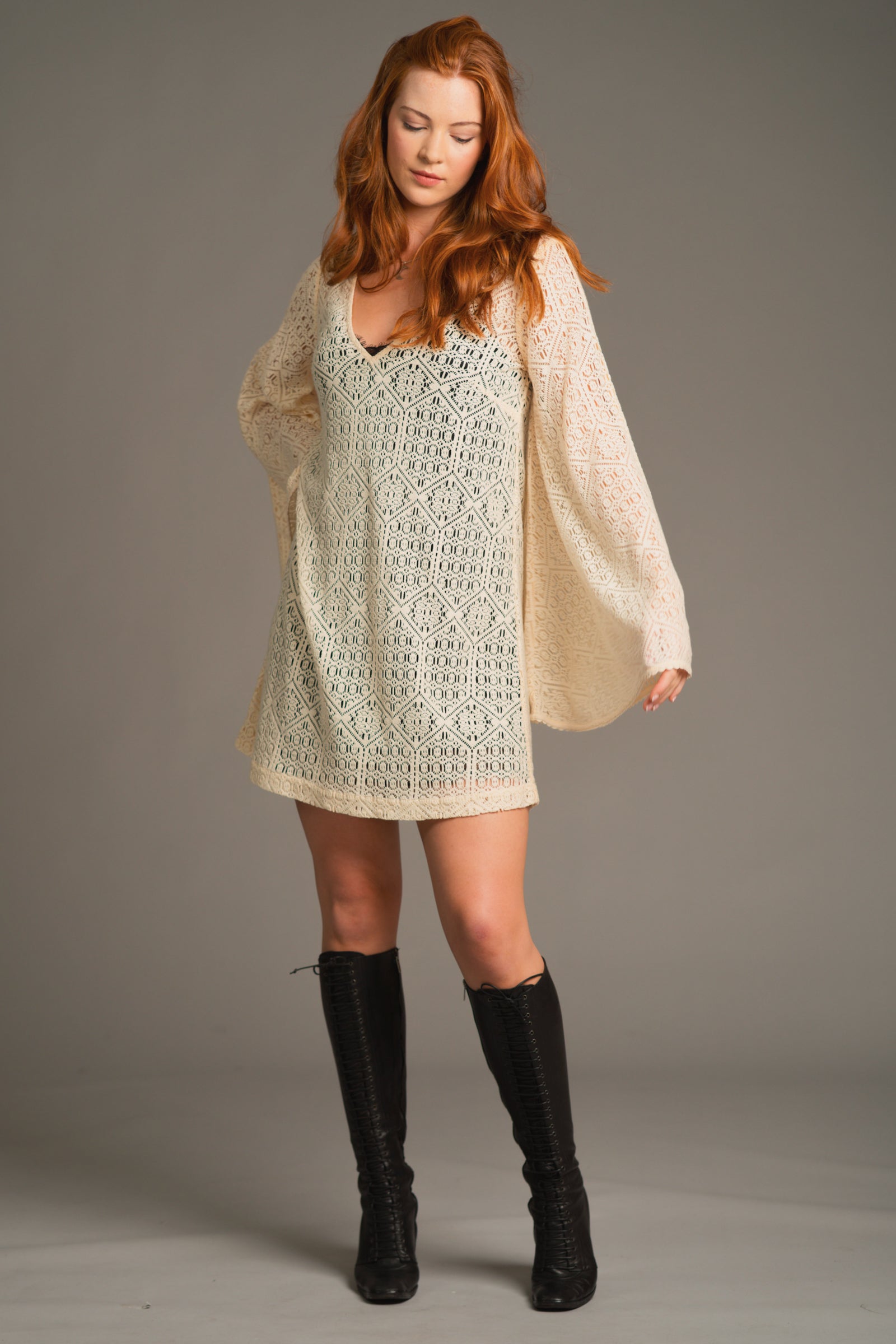 Front view of the Goldie Crochet Mini Dress with crochet detail, flared sleeves and relaxed V-neckline