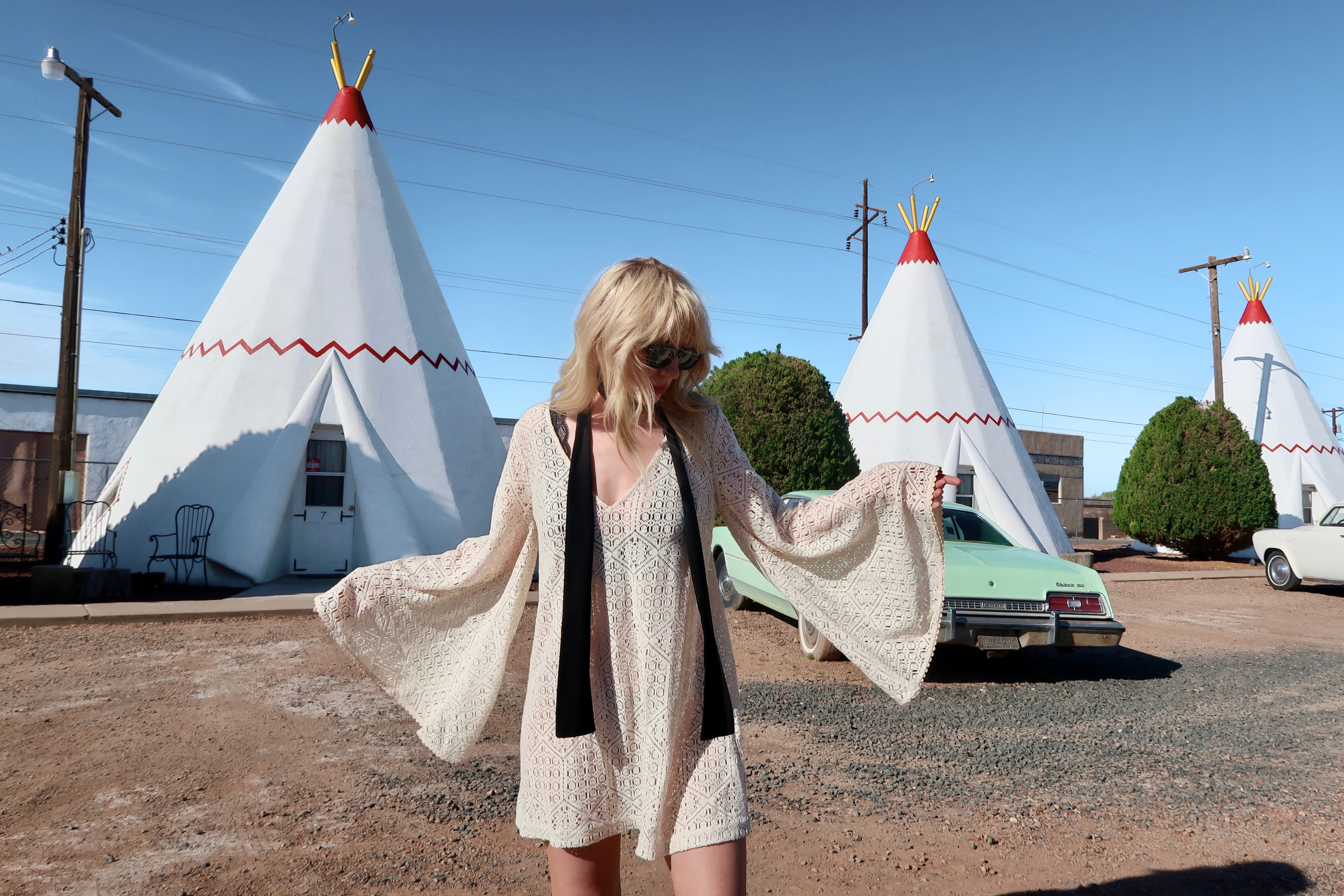Model wearing the boho Goldie ivory flared sleeved mini dress. Western style