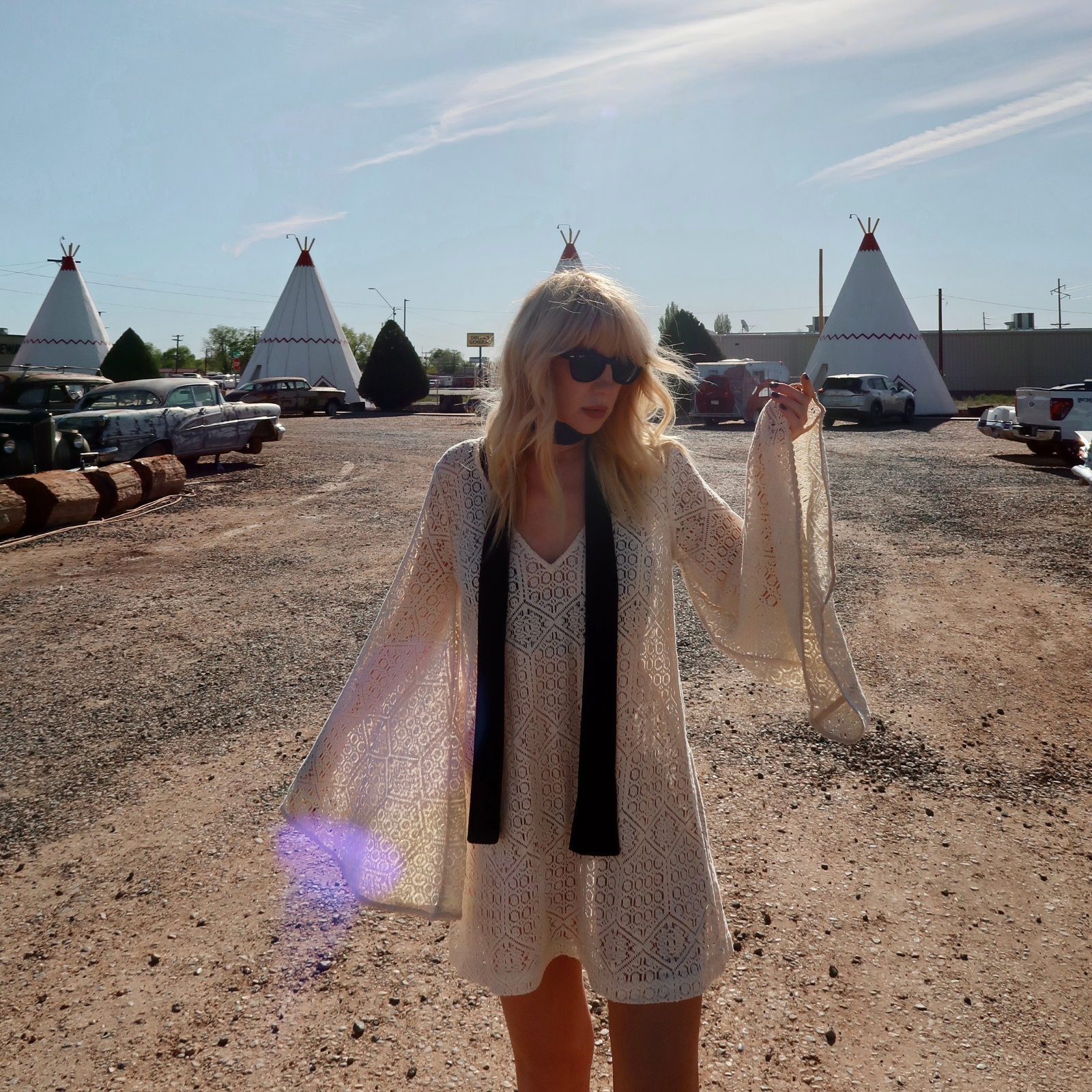 Model wearing the boho Goldie ivory flared sleeved mini dress. Western style