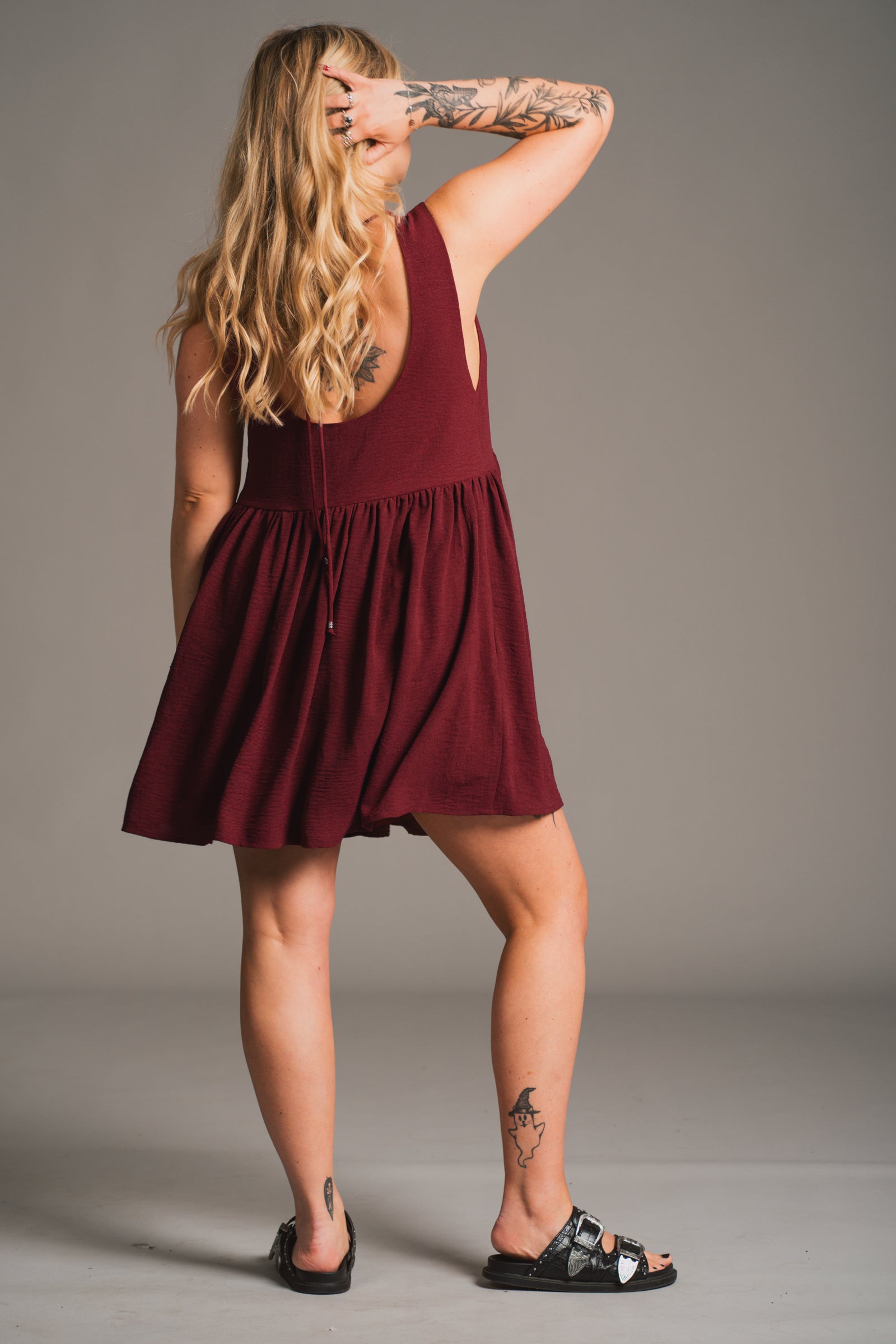 Back view of Little Lies Grace Plum Smock Dress showing scoop back and tie detail