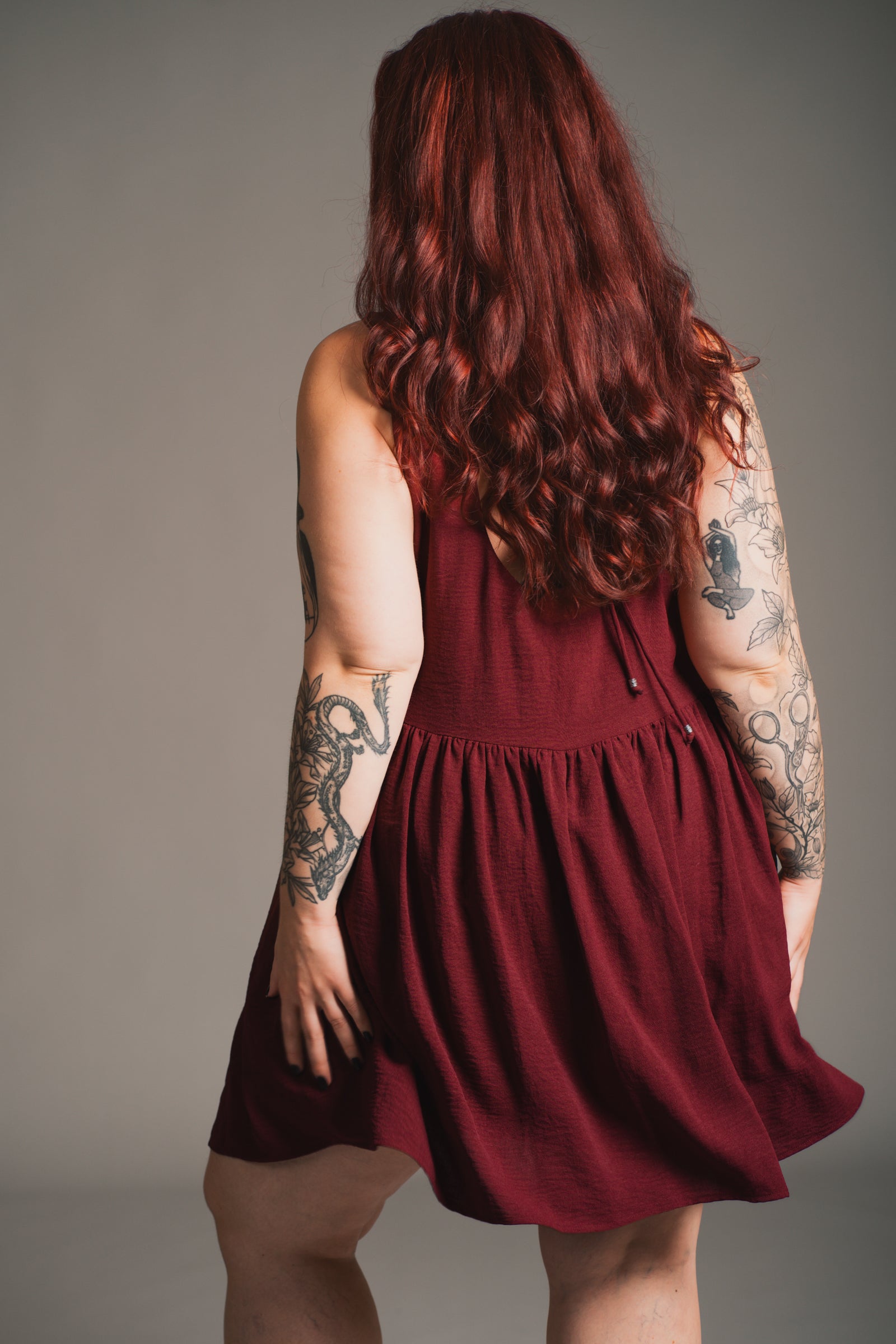 Little Lies Grace Plum Smock Dress with side splits showing functional pocket detail