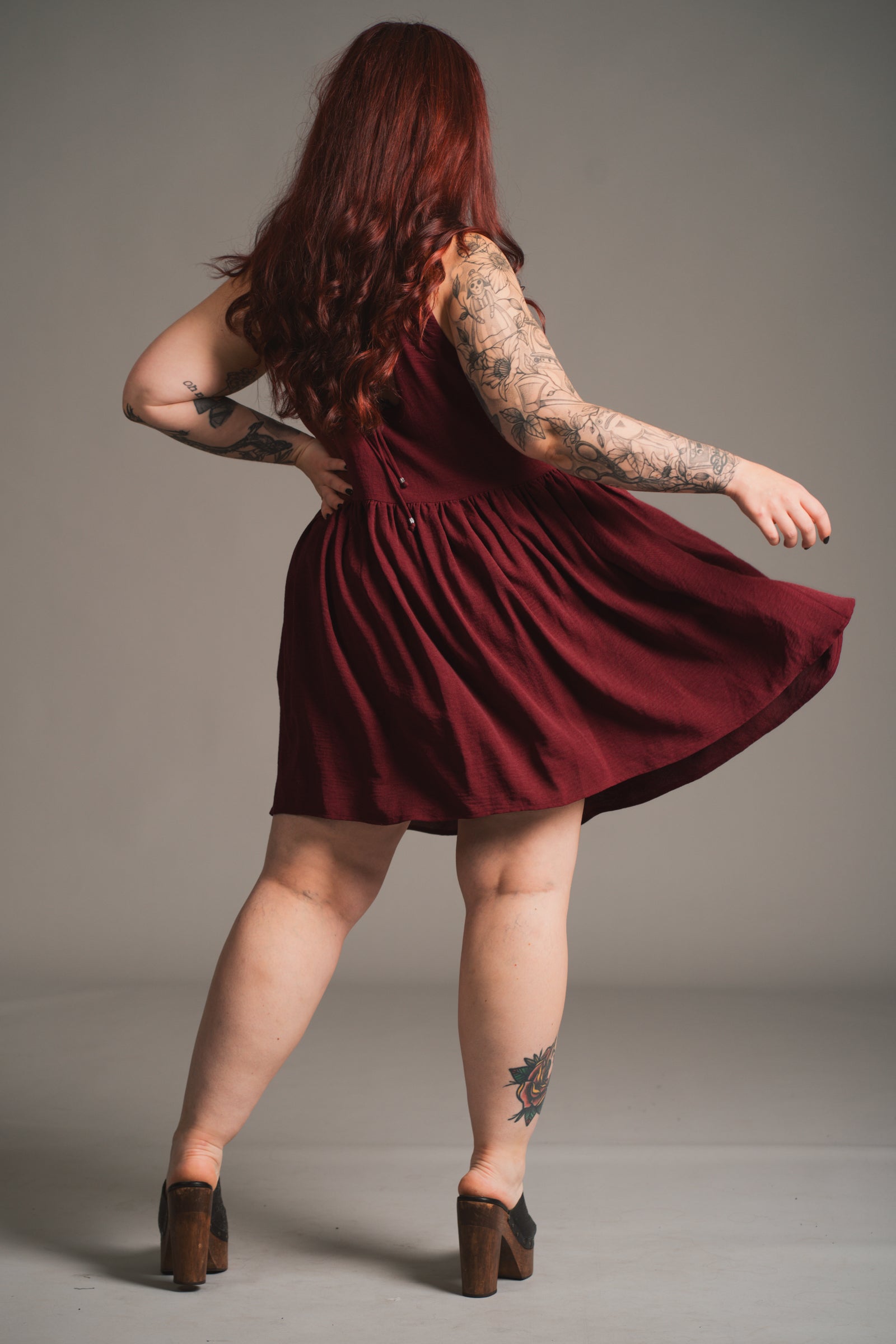 Little Lies Grace Plum Smock Dress worn showing deep plum colour and smock shape in movement