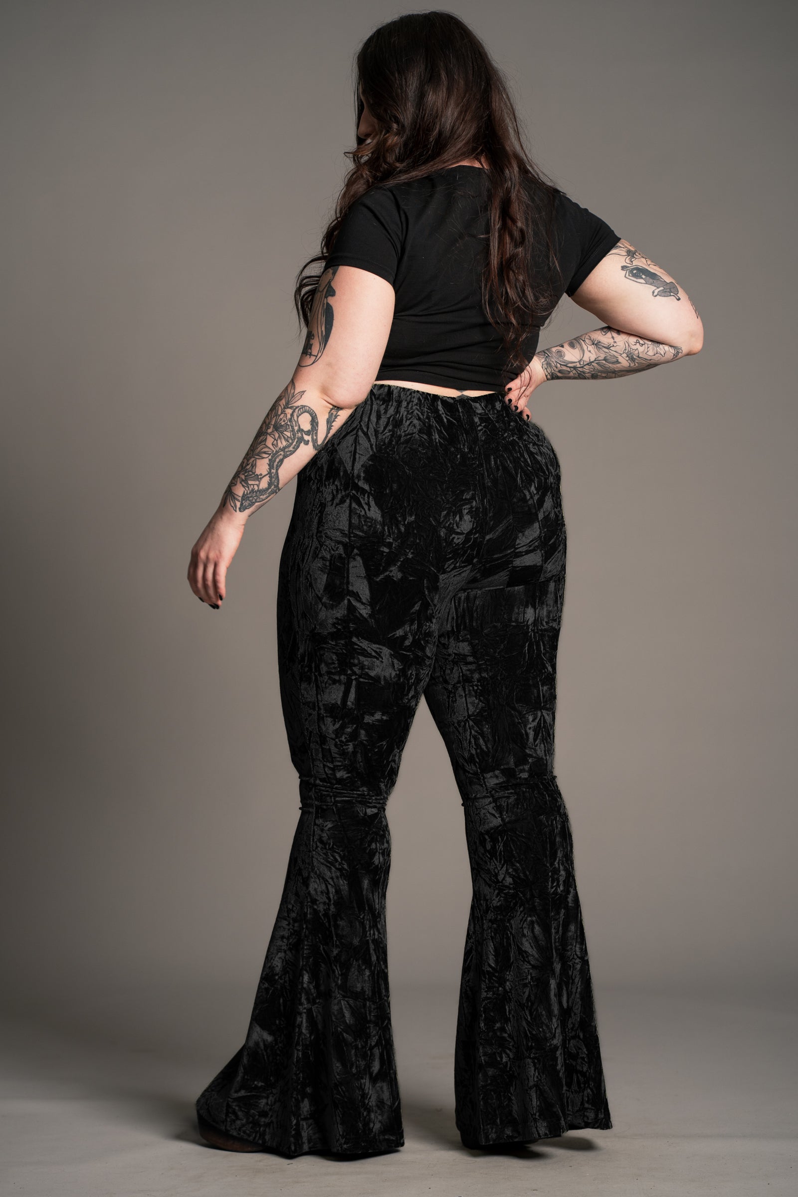 Plus size back view of the Hendrix Black Crushed Velvet Flares showing flared leg silhouette.