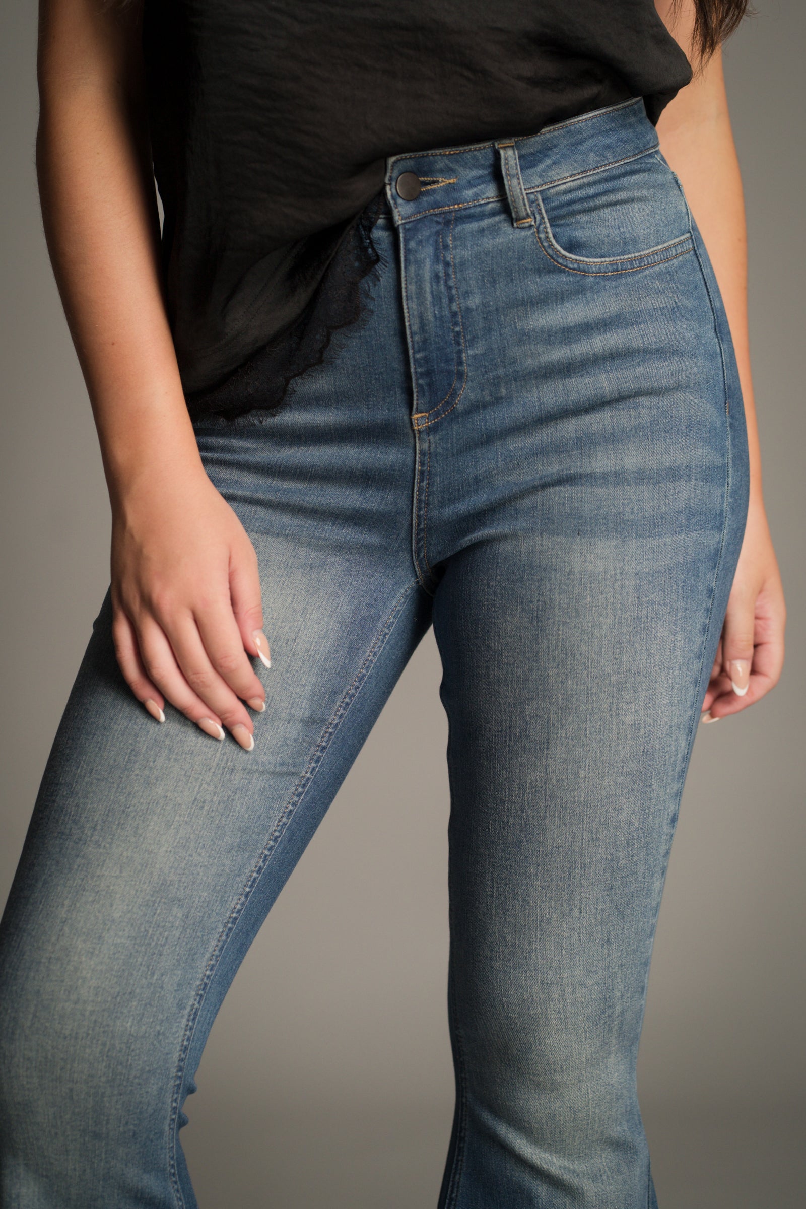 Full length front view of the Hendrix Blue Denim Flares styled with a band tee.
