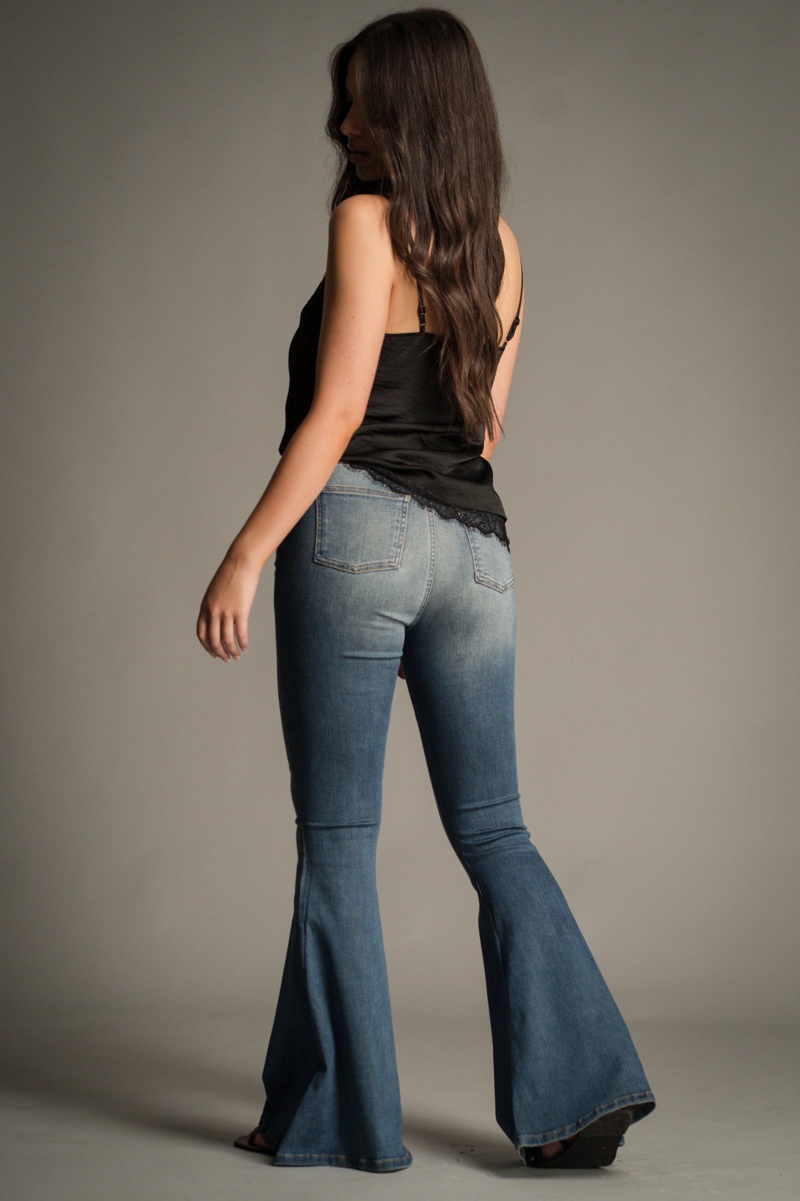 Back view of the Hendrix Blue Denim Flares showing bell-bottom flare and high-waist silhouette.