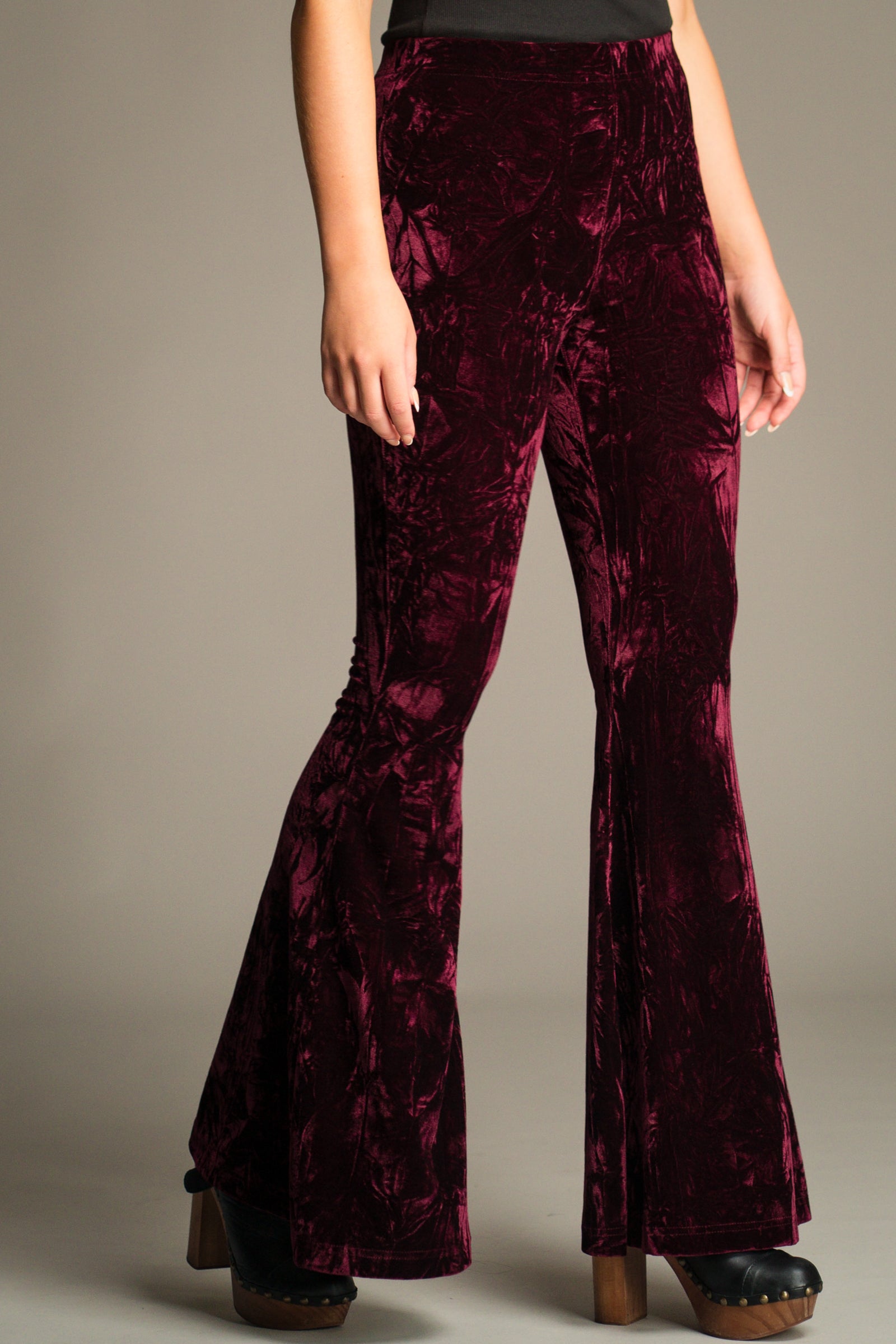 Close-up front view of the Hendrix Merlot Crushed Velvet Flares showing high-rise fit and velvet texture.