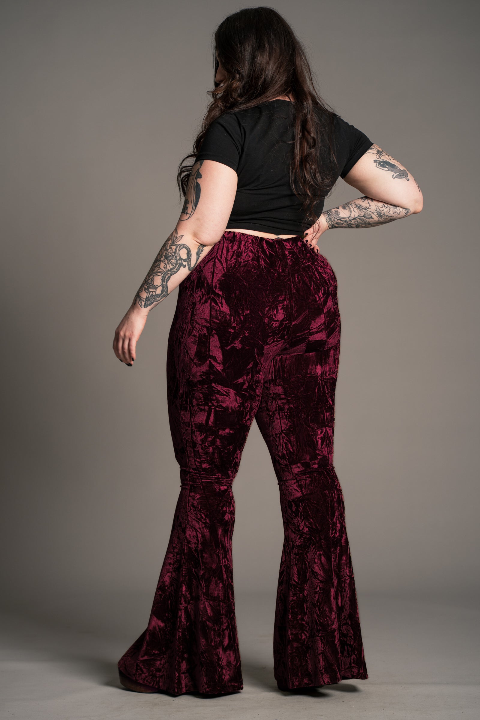 Plus size back view of the Hendrix Merlot Crushed Velvet Flares showing flared leg silhouette.