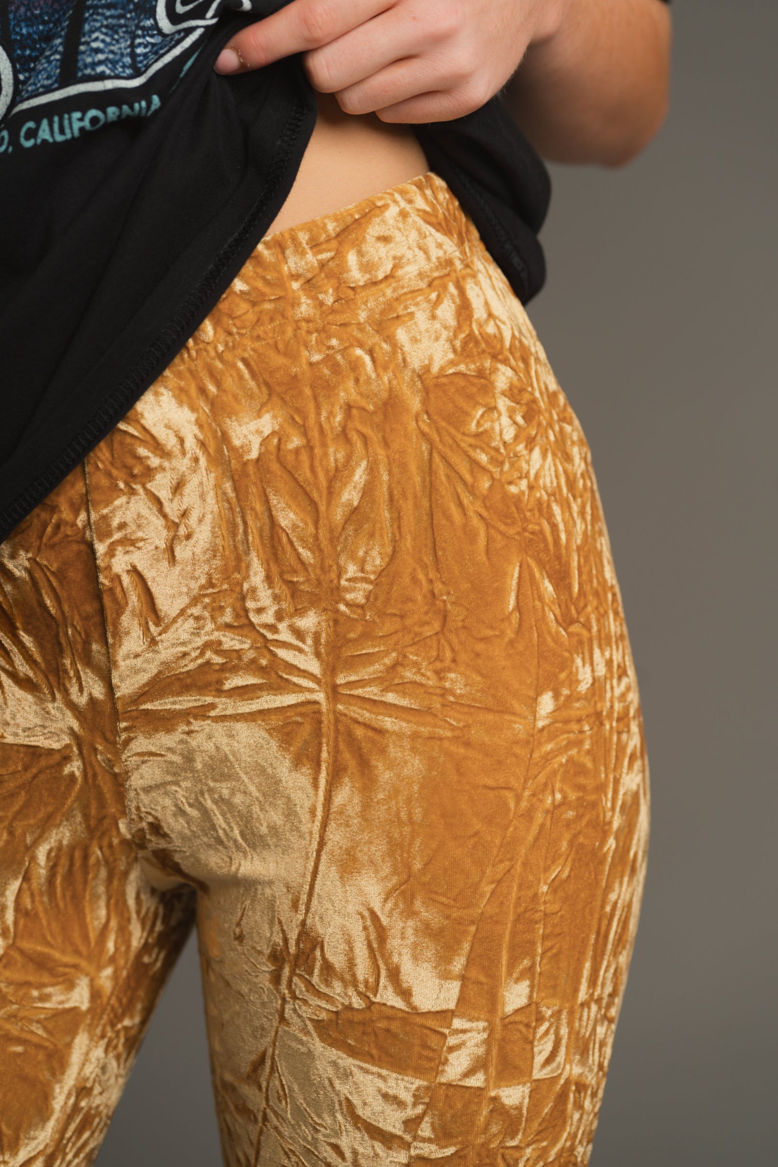 Close-up of crushed velvet fabric on Hendrix flares showing buttery sheen and rich texture