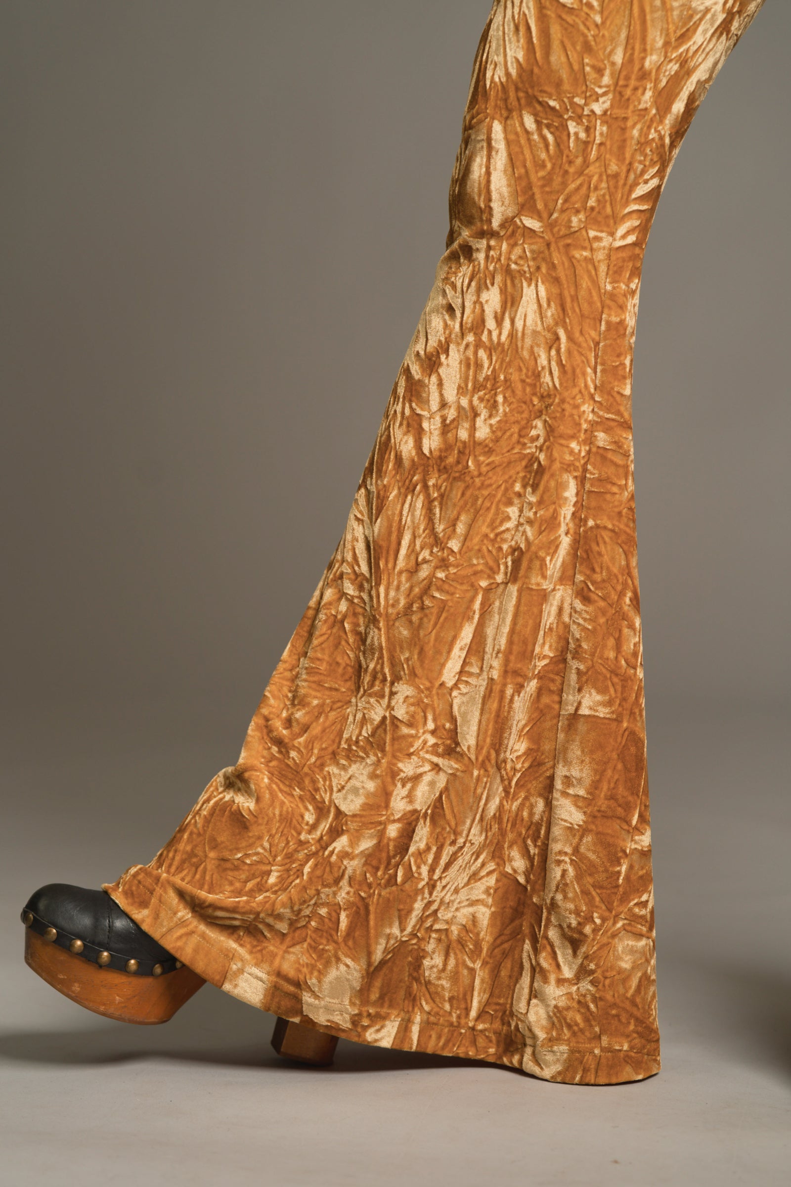 Cropped shot of Hendrix Ochre Velvet flares draping over black platform shoes with retro styling