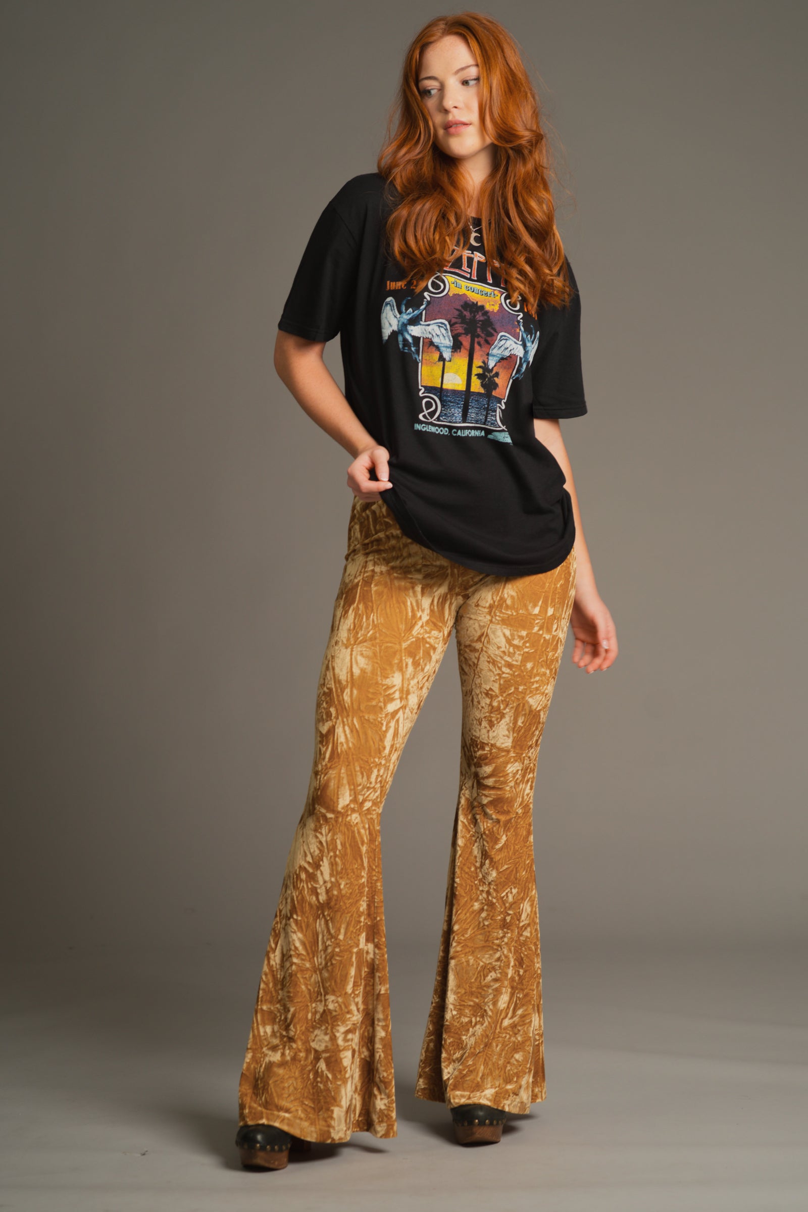Front view of Anna wearing Hendrix Ochre crushed velvet flares with Led Zeppelin Inglewood band tee