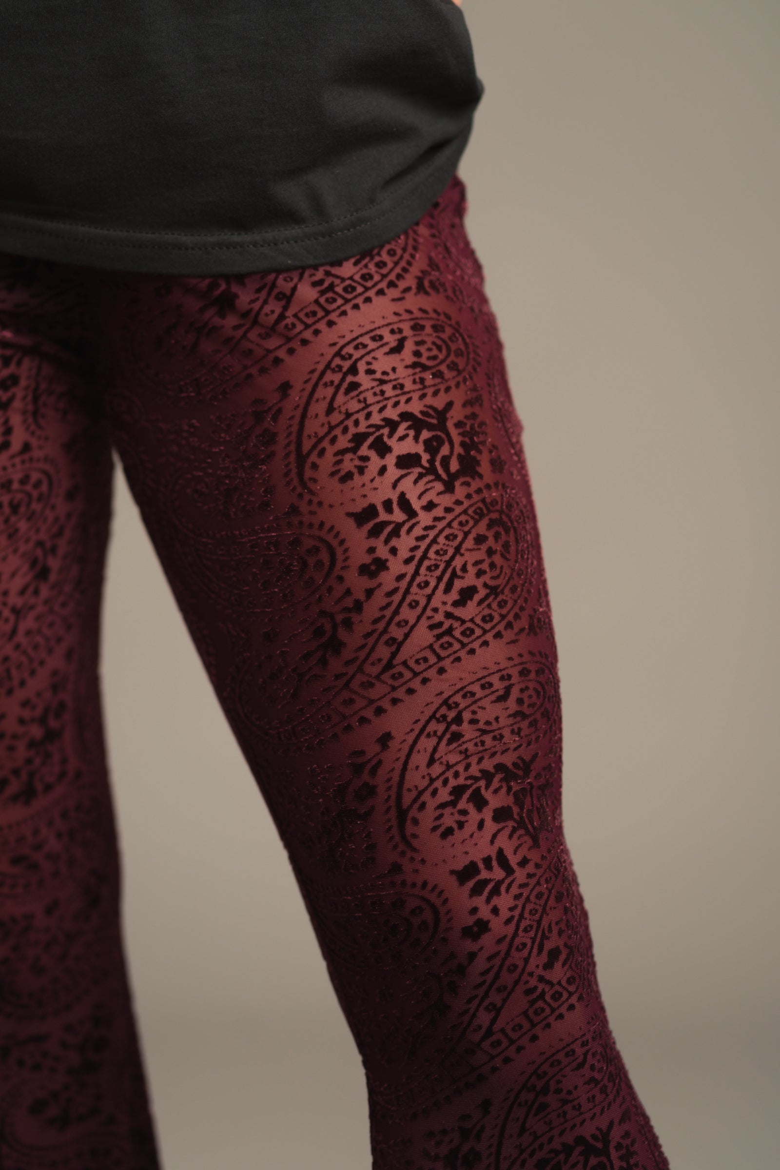 Close-up of plum burnout velvet fabric with paisley devore pattern on 70s inspired Hendrix Flares.