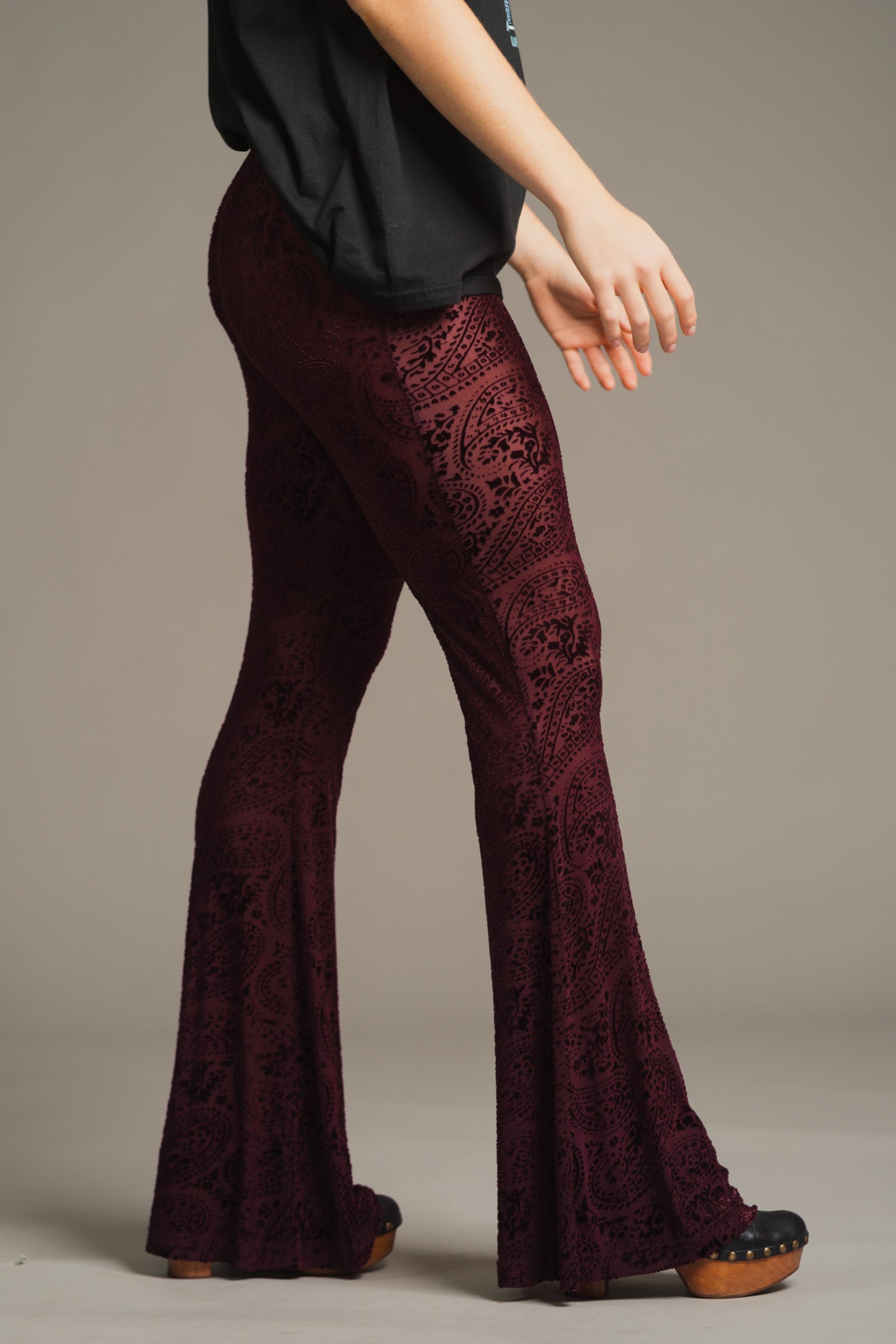 Side profile of Hendrix Plum Devore flares in burnt out velvet with paisley pattern.