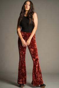Hendrix Rust Crushed Velvet Flares by Little Lies featuring a flattering high-waisted silhouette and statement seventies-inspired flare