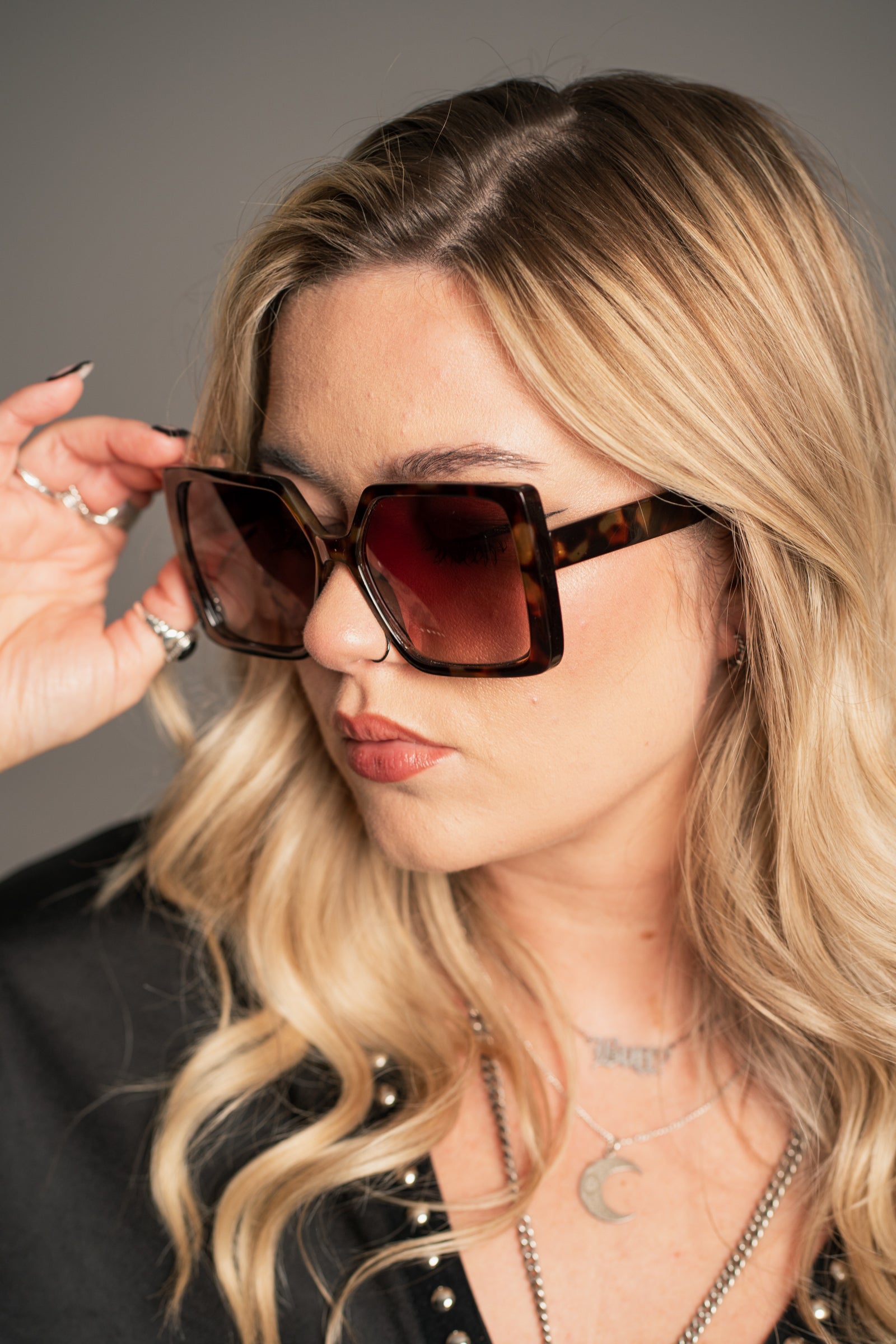 Close-up of Little Lies Jerry Oversized Square Sunglasses showing tortoiseshell texture and gradient lens detail