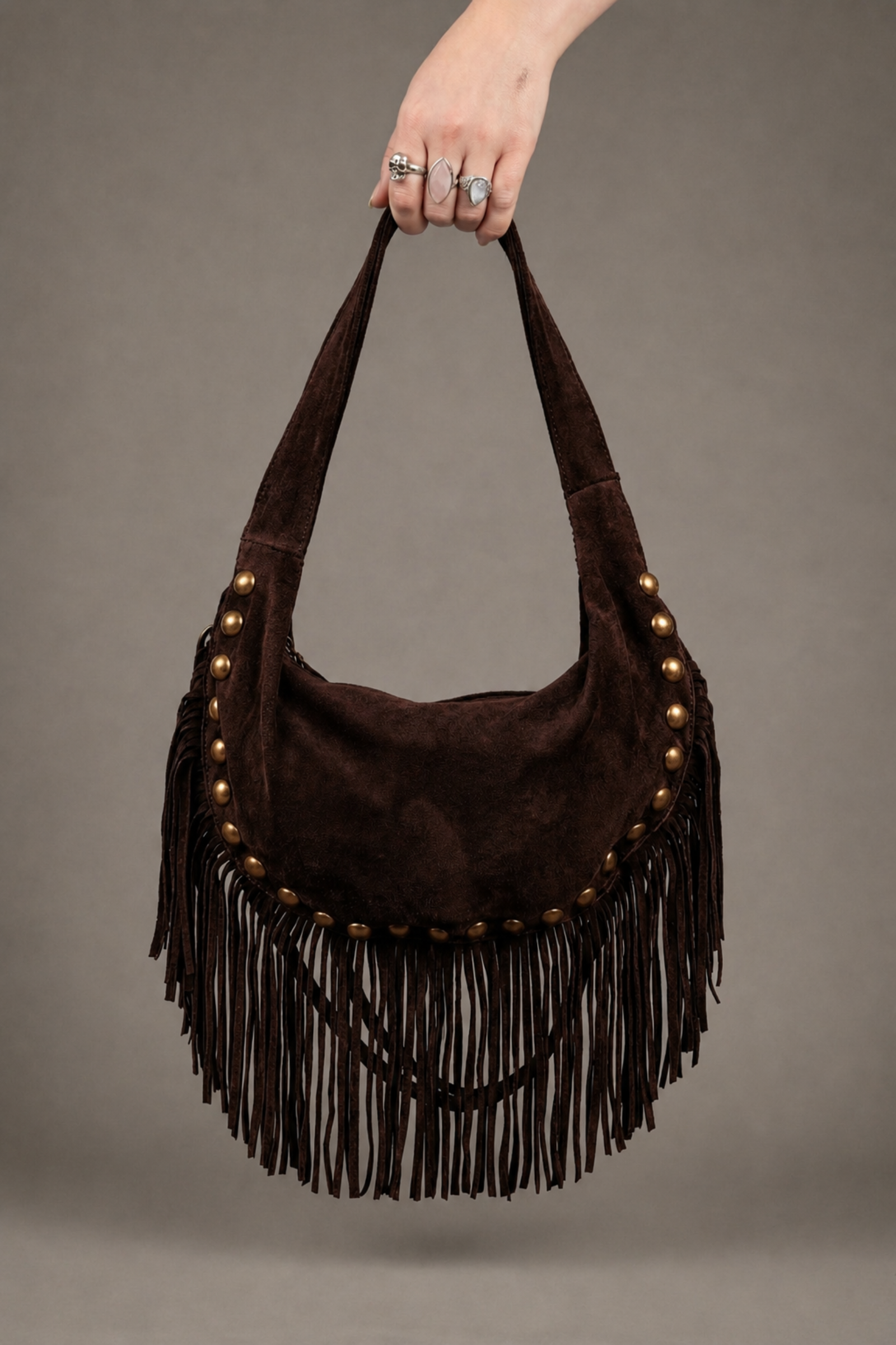 Little Lies Kate chocolate suede studded fringe bag – side profile on model showing fringe movement