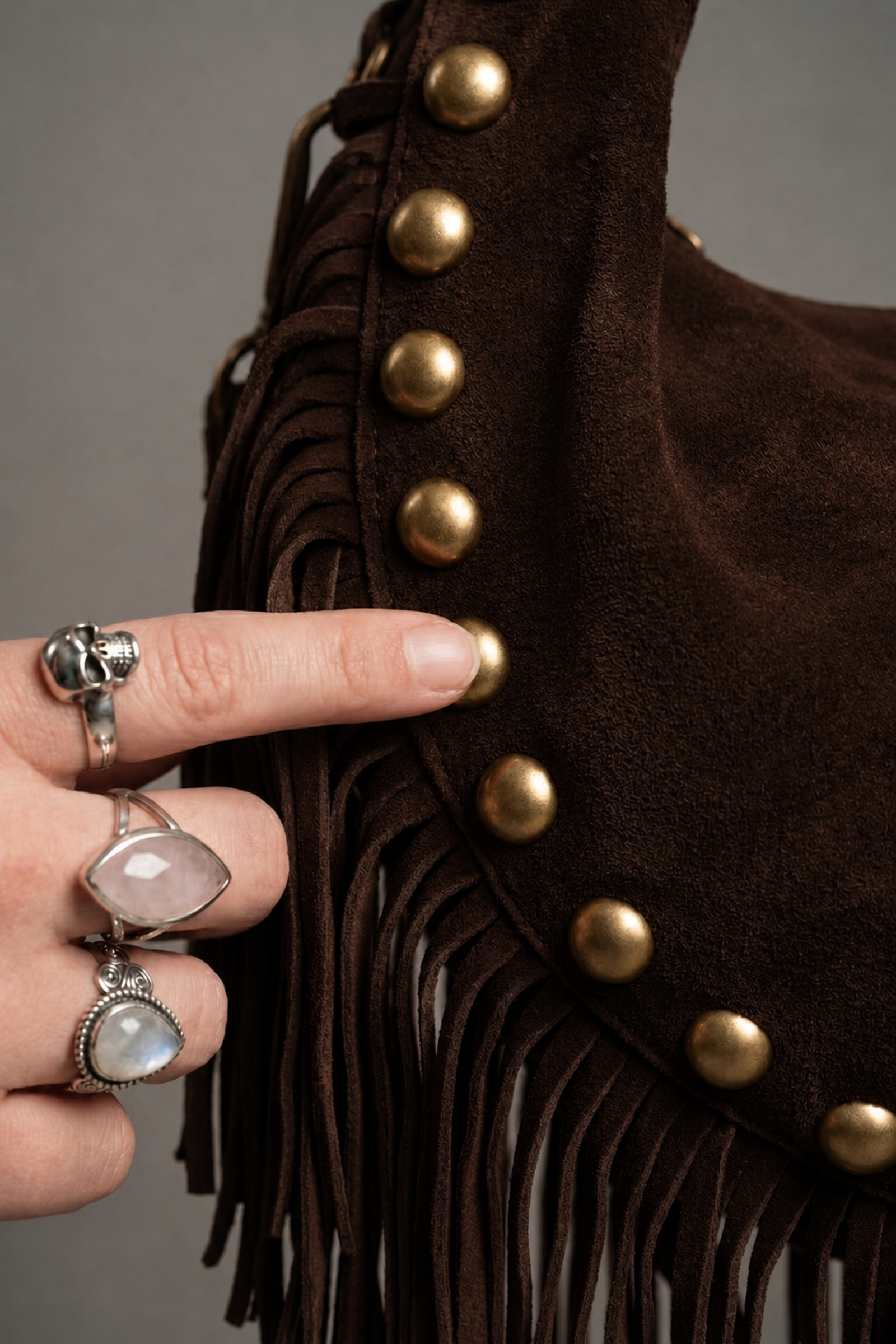 Little Lies Kate chocolate suede studded bag detail with fringe trim and gold stud accents close-up
