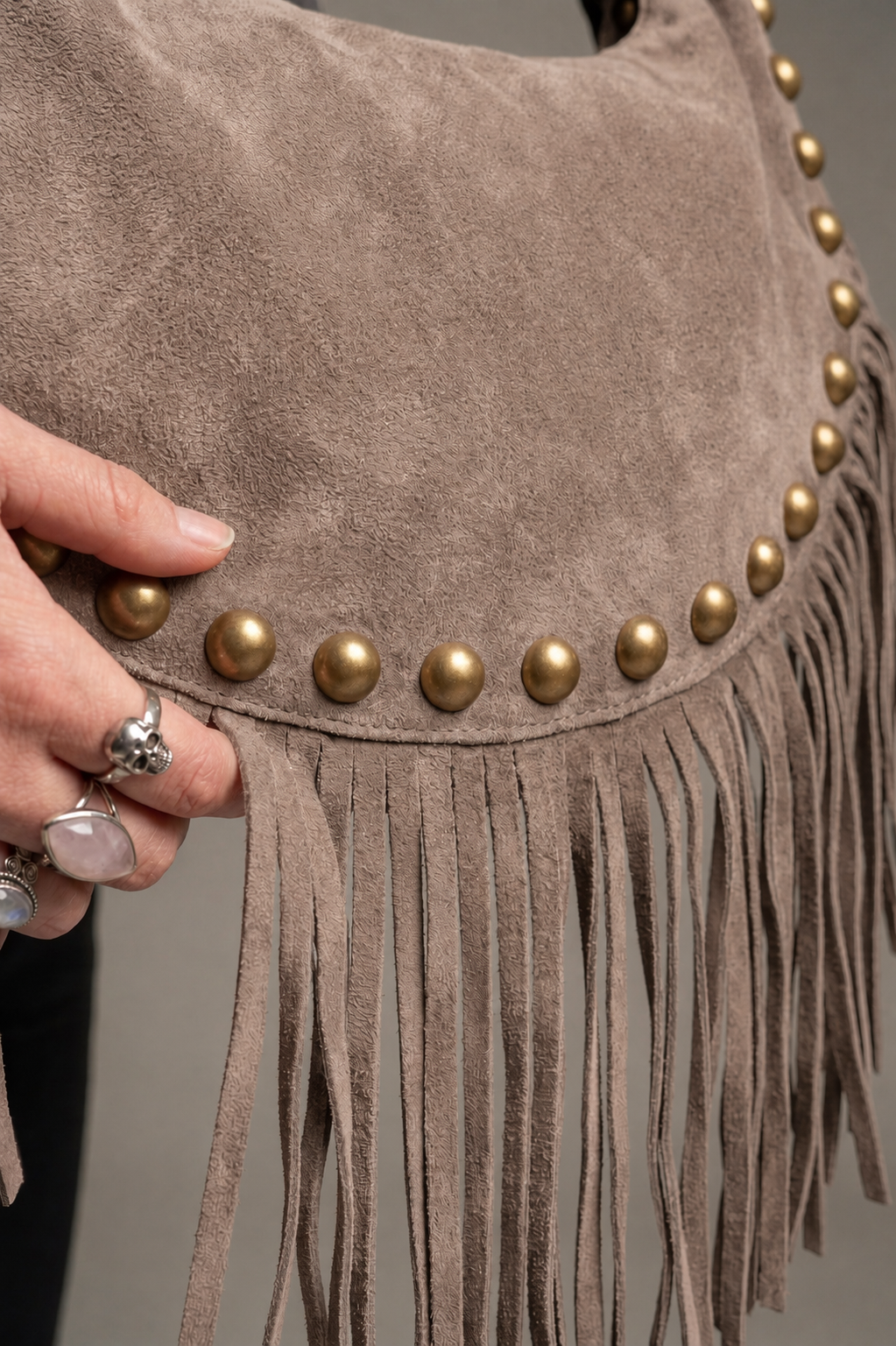 Little Lies Kate taupe genuine suede studded fringe bag with gold stud detailing and tassel trim, close‑up texture view