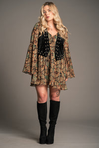 Model wearing Little Lies Lennon black studded velvet waistcoat styled with printed boho mini dress and knee-high boots for relaxed everyday outfit