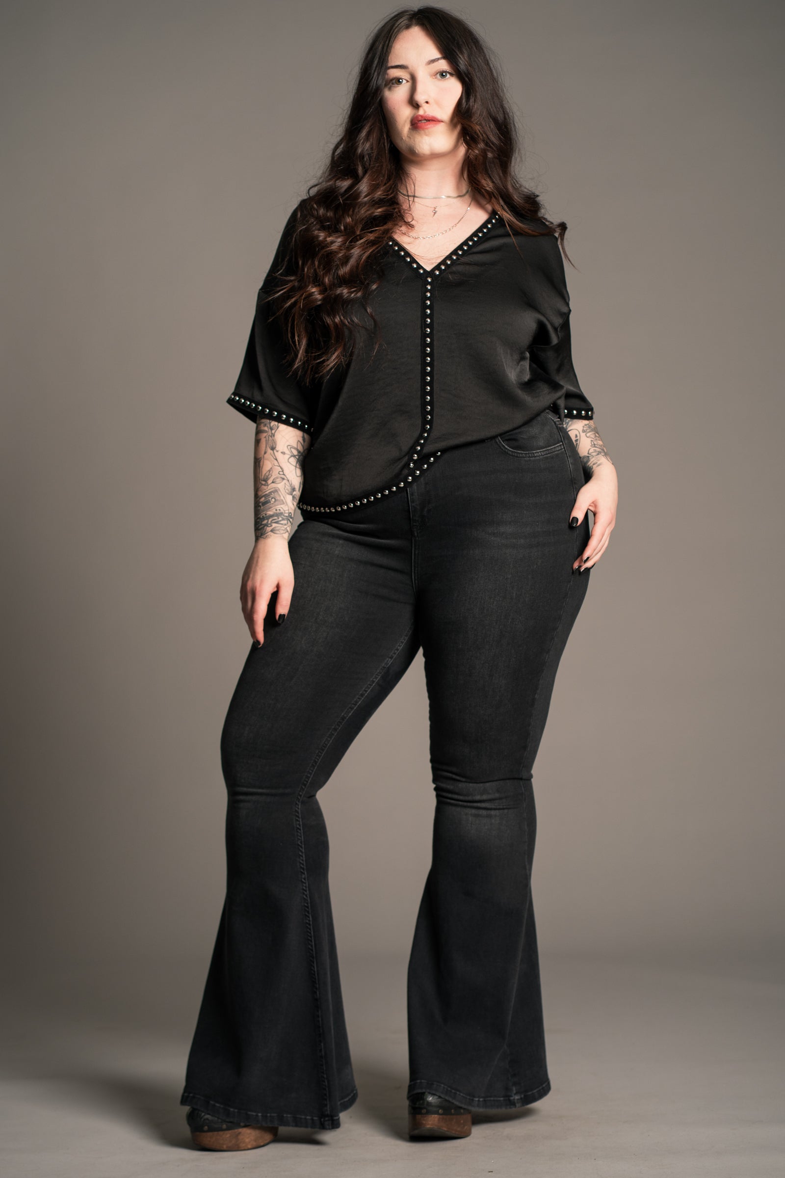 Close-up of velvet-backed stud detailing on Little Lies Lita Studded Satin Tee in black satin
