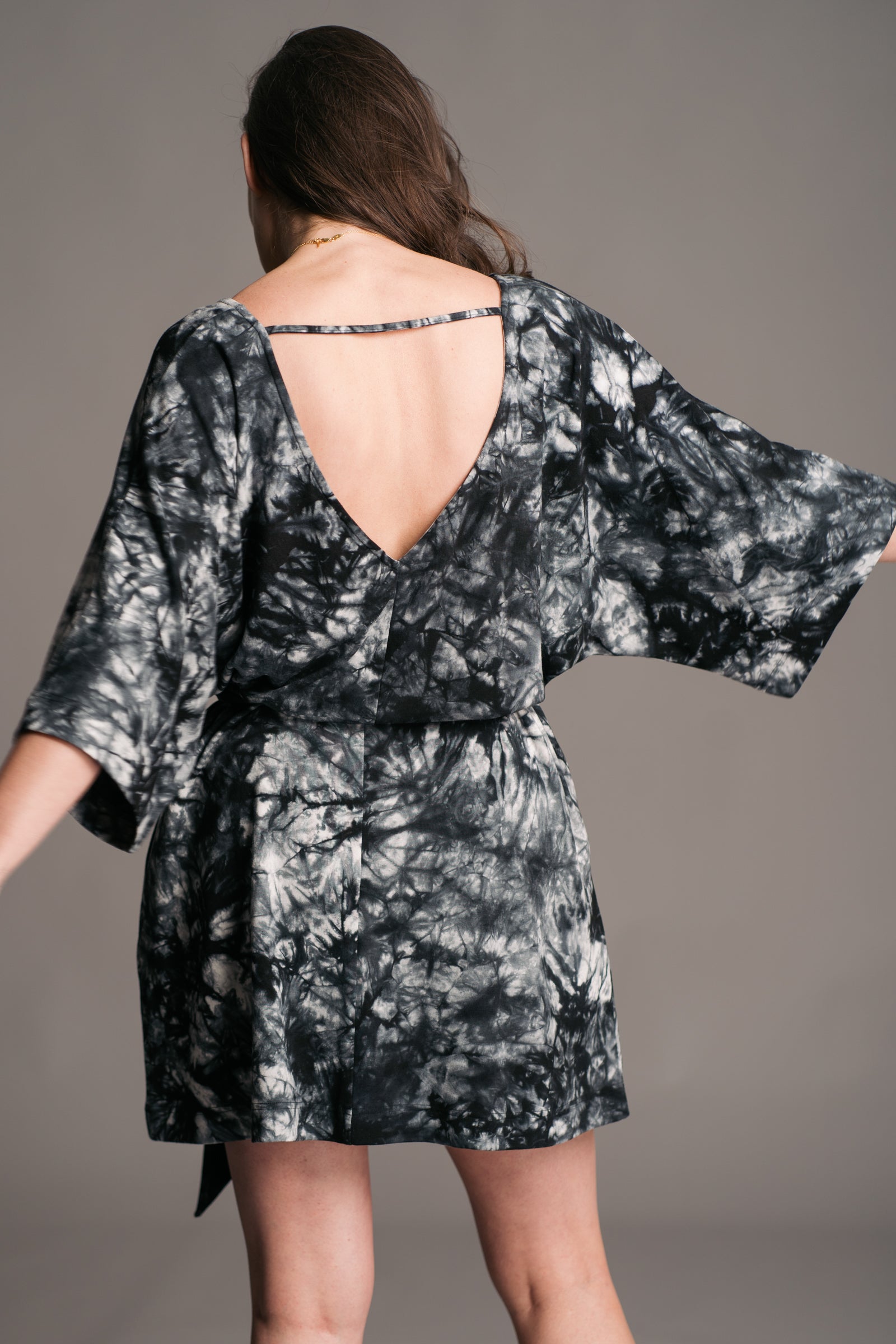 Joplin Tie Dye Mini Dress worn onset by brunette model, Bex, also wearing black leather wooden clogs.