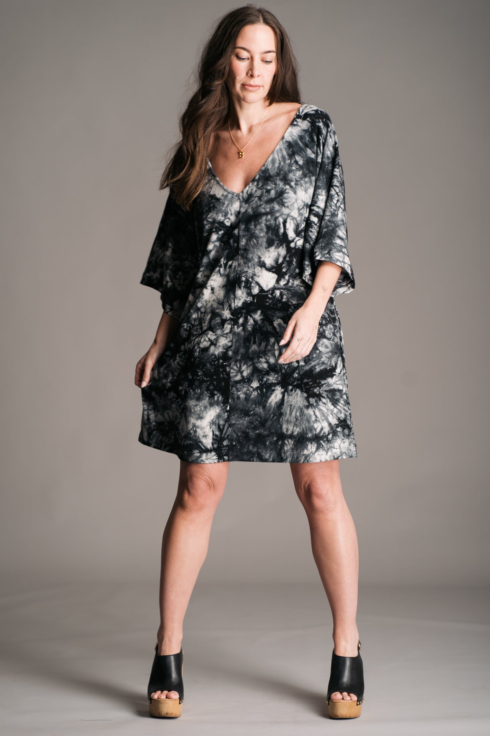 Joplin Tie Dye Mini Dress worn onset by brunette model, Bex, also wearing black leather wooden clogs.Shown without waist tie